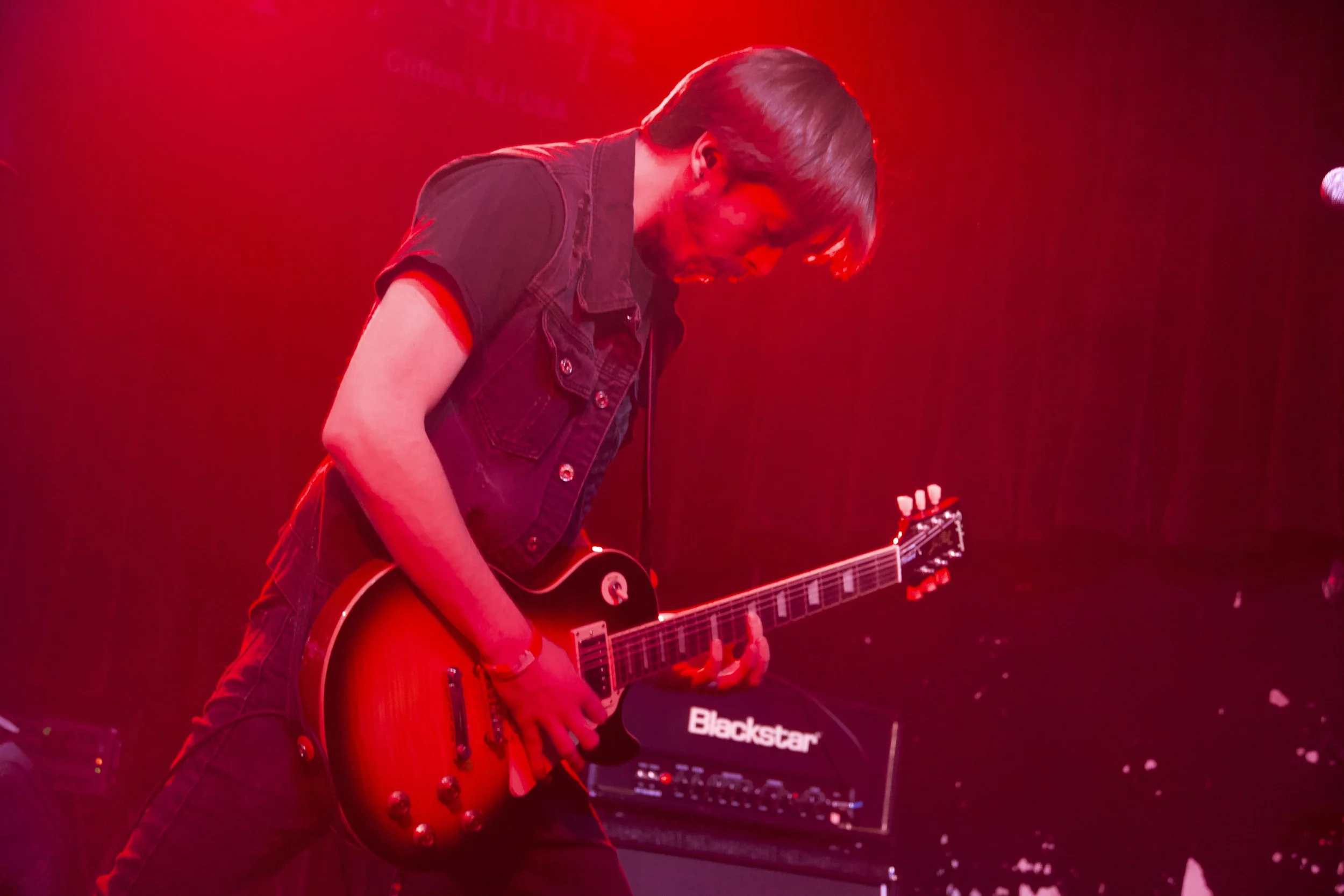 Guitarist Ryan Hartell playing Les Paul live on stage.