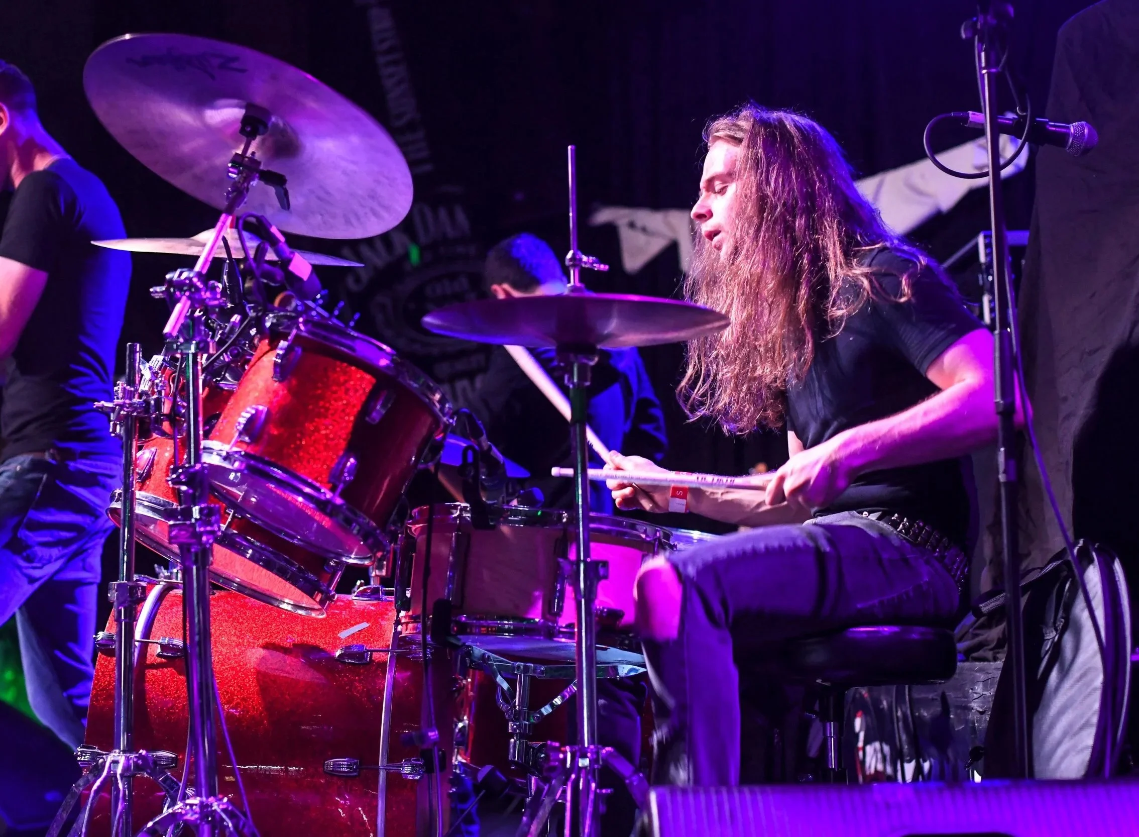 Side view shot of drummer Mason Servedio performing live at Whisky A Go Go