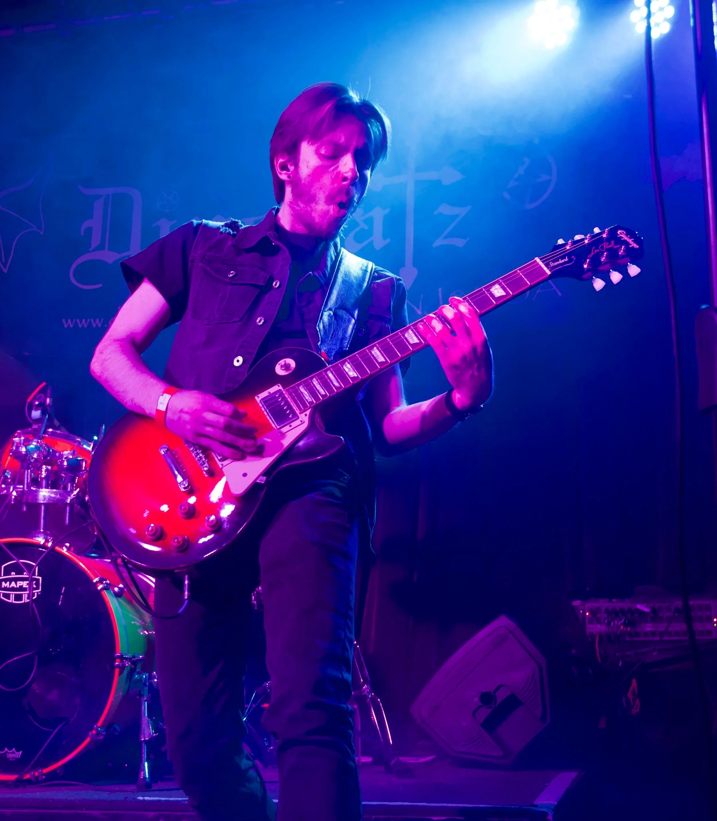 Guitarist Ryan Hartell playing Les Paul live on stage.