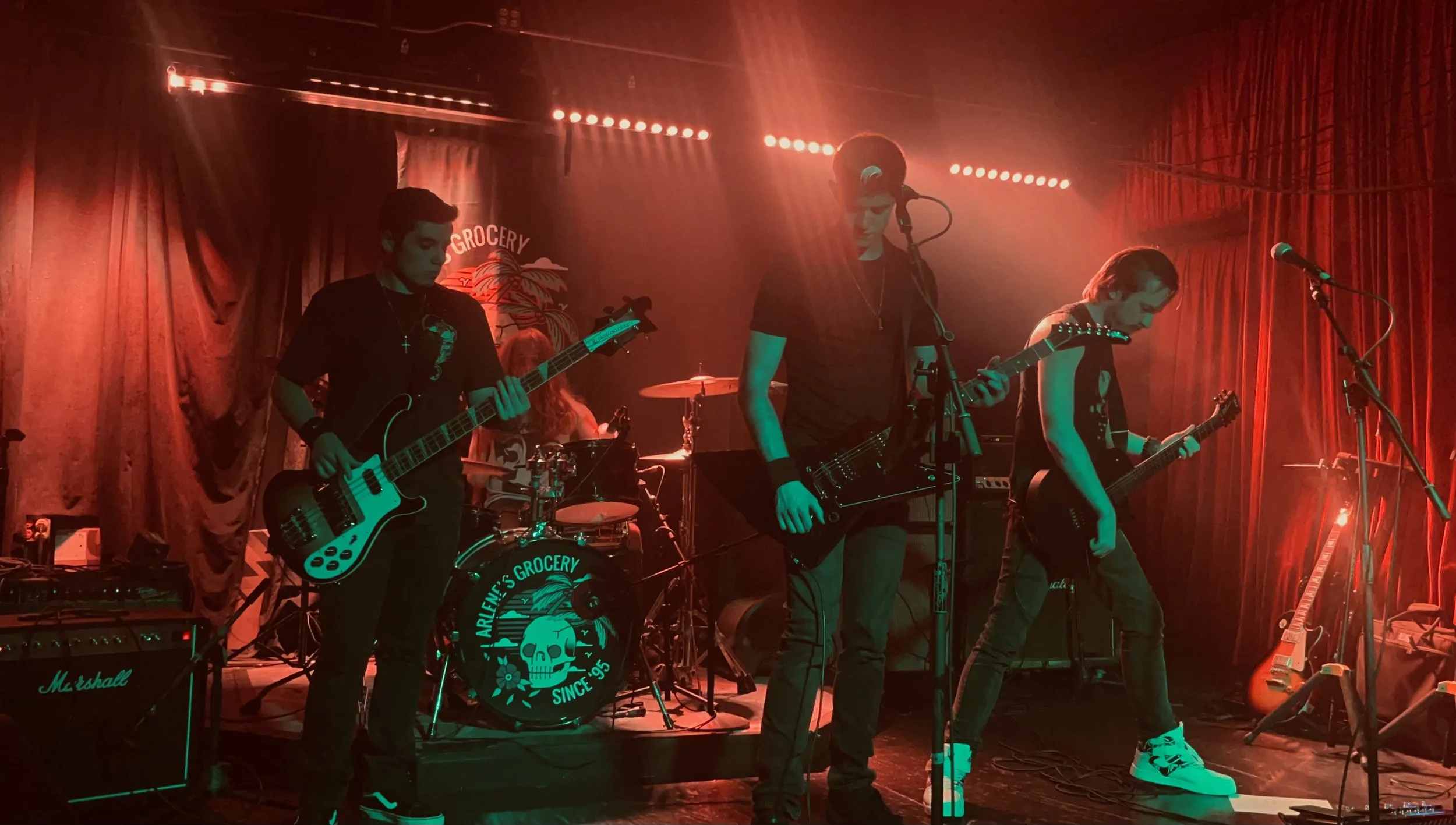 Mainline performing live in NYC with orange and green backing stage lights.