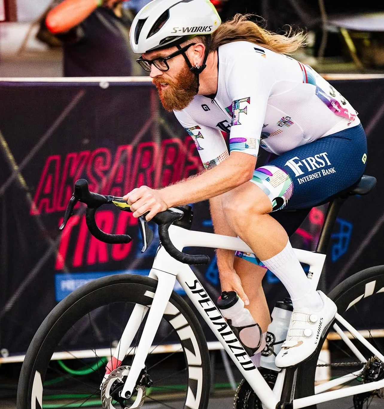 Close-up of a racer, wearing a helmet, glasses and gear to race in the Aksarben Tirc Criterium.