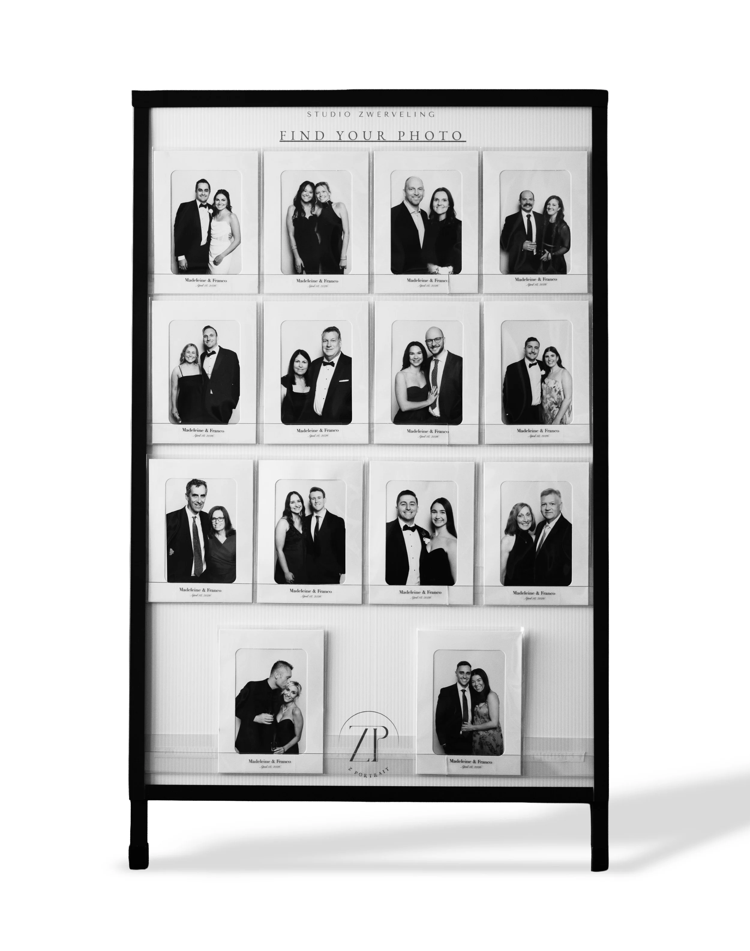 A photo display case with multiple black-and-white portrait photos of couples, labeled with names and dates, with a sign above that reads "Find Your Photo" and a logo at the bottom.