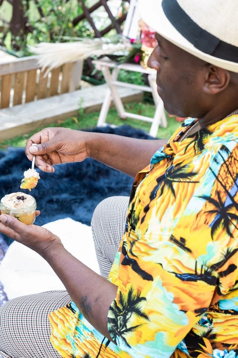 Lifestyle photography of model eating vegan pudding, free-from dessert experience shoot in home garden, joyful and indulgent