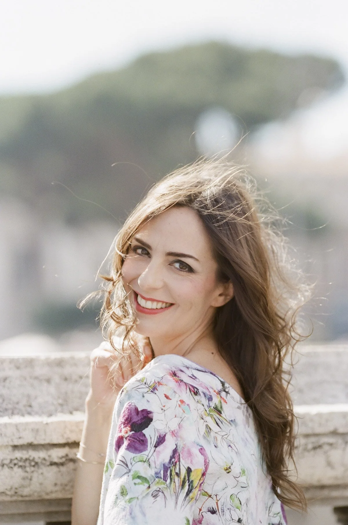 Bespoke portrait session in Rome, a woman in a dress on St Angelo bridge next to the Vatican shot on Kodak Portra 400