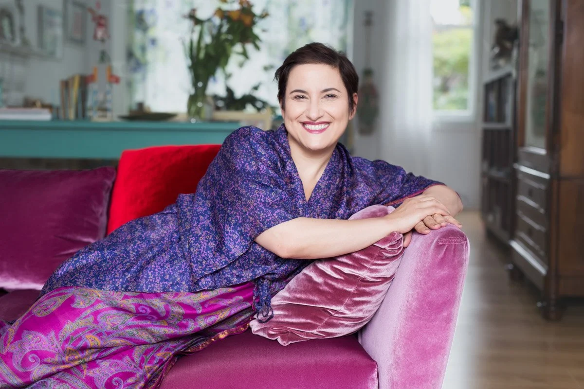 Natural light portrait of a person in their living room, an example of a comfortable home-based photoshoot.