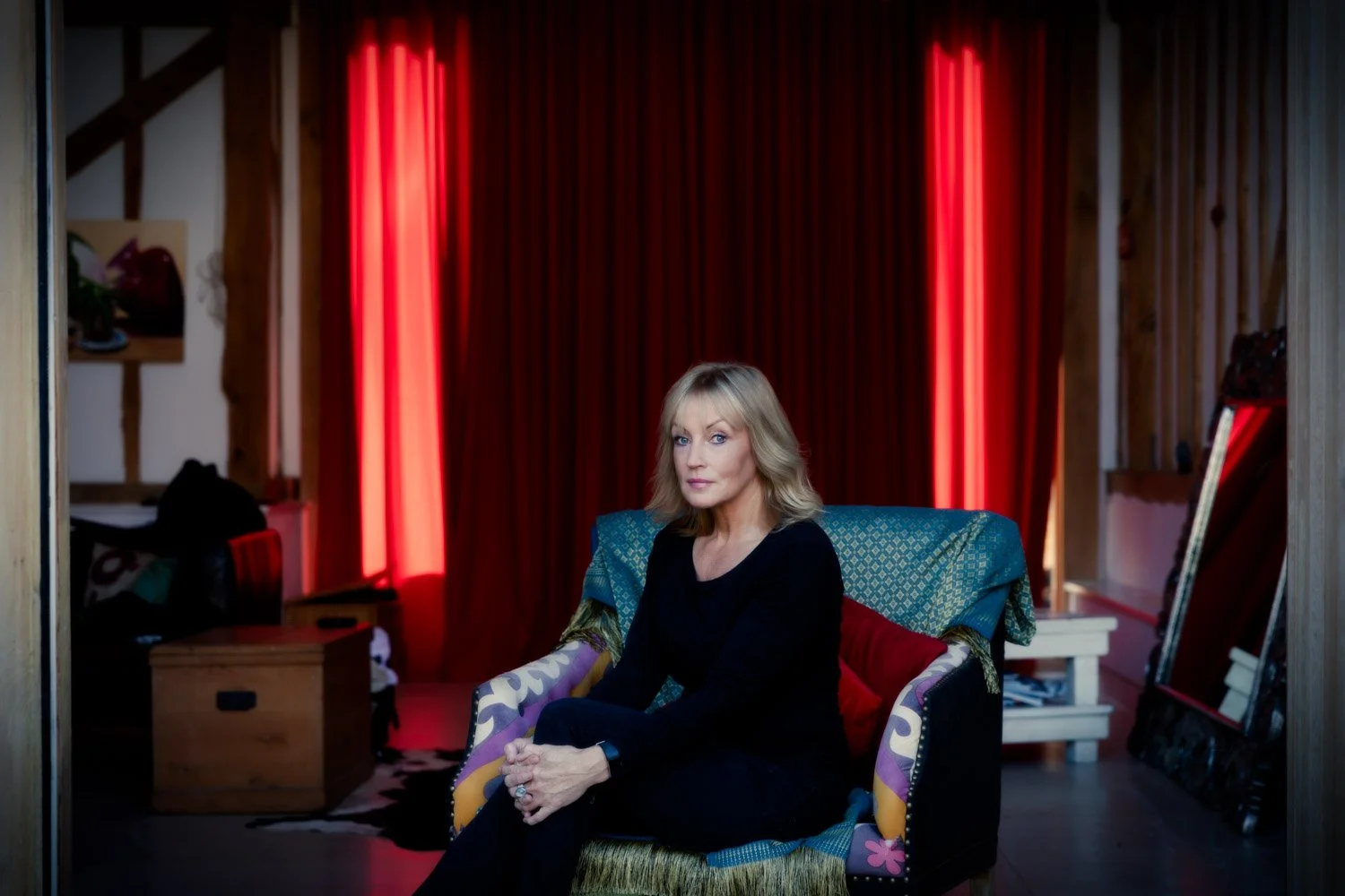 elaxed lifestyle portrait of a woman sitting on her sofa at home, ideal for those looking to test the water with a natural photoshoot.