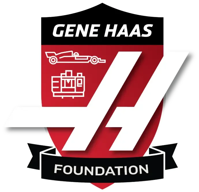 Logo for Gene Haas Foundation featuring a black and red shield with white text and icons, including a race car and machinery components.