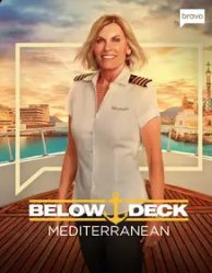Woman in a white captain's uniform standing on a cruise ship deck with a sunset background, promotional text reading 'Below Deck Mediterranean'.