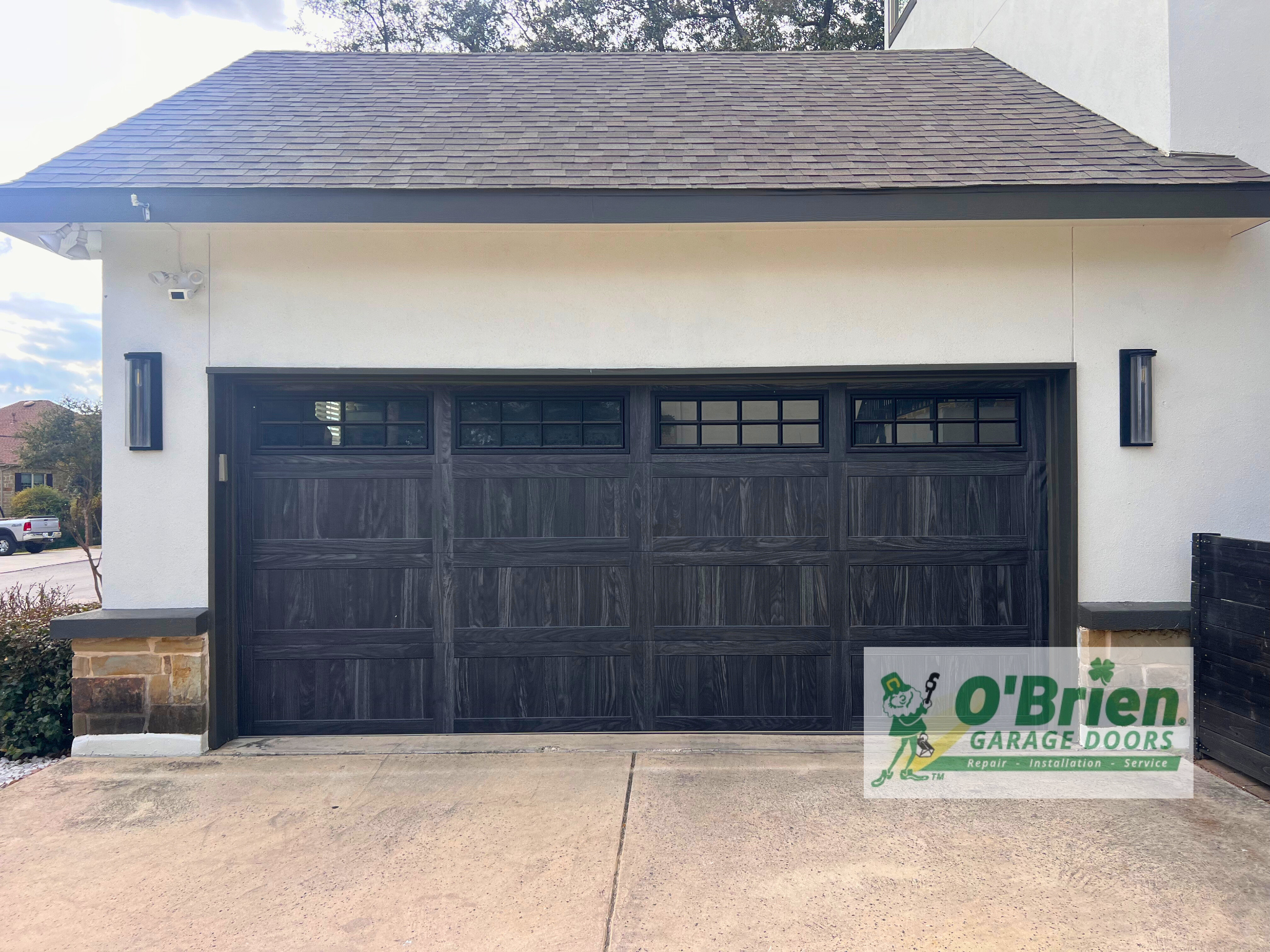 White House With Dark Brown Wooden Garage Door With Windows