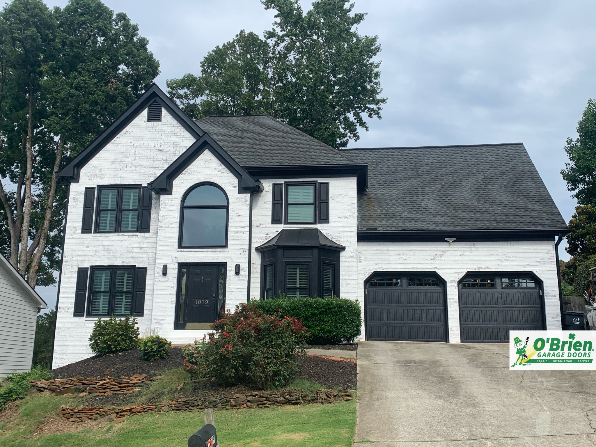 White House with Black Garage Doors