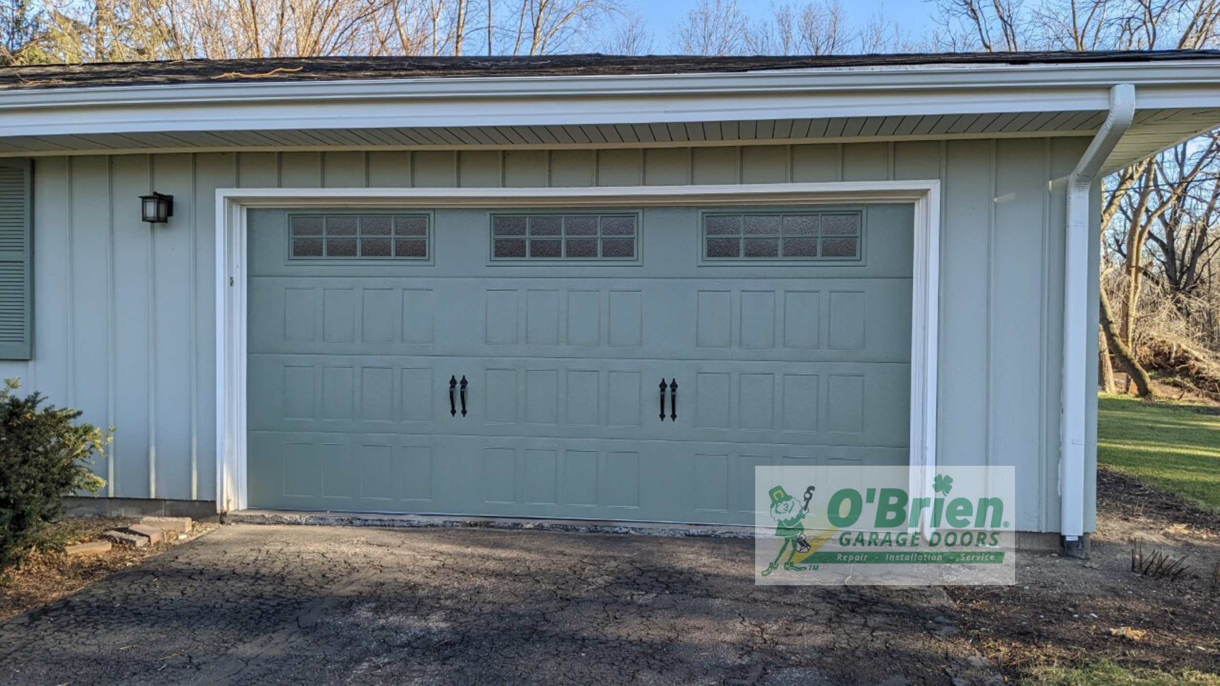 Light Grey House With Light Green(?) Garage Door
