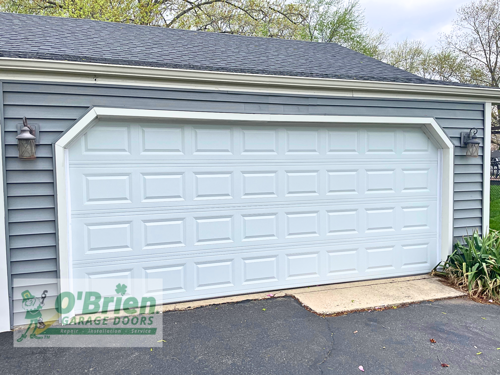 White Paneled Garage Door on Gray Paneled House