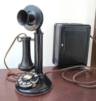 Antique black candlestick telephone - use to make a phone call to Bauer Insurance Agency
