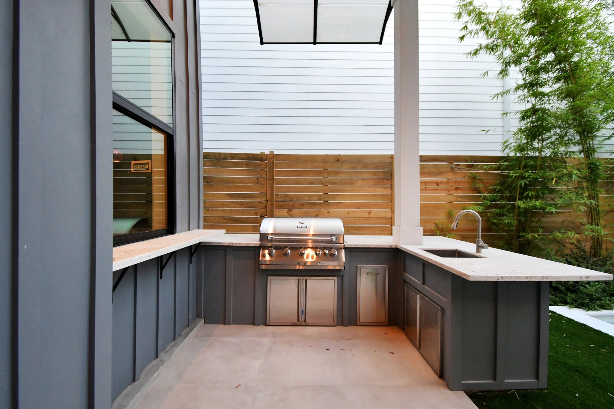 A private outdoor kitchen featuring a built-in grill and clean modern finishes—perfect for effortless al fresco dining and entertaining.