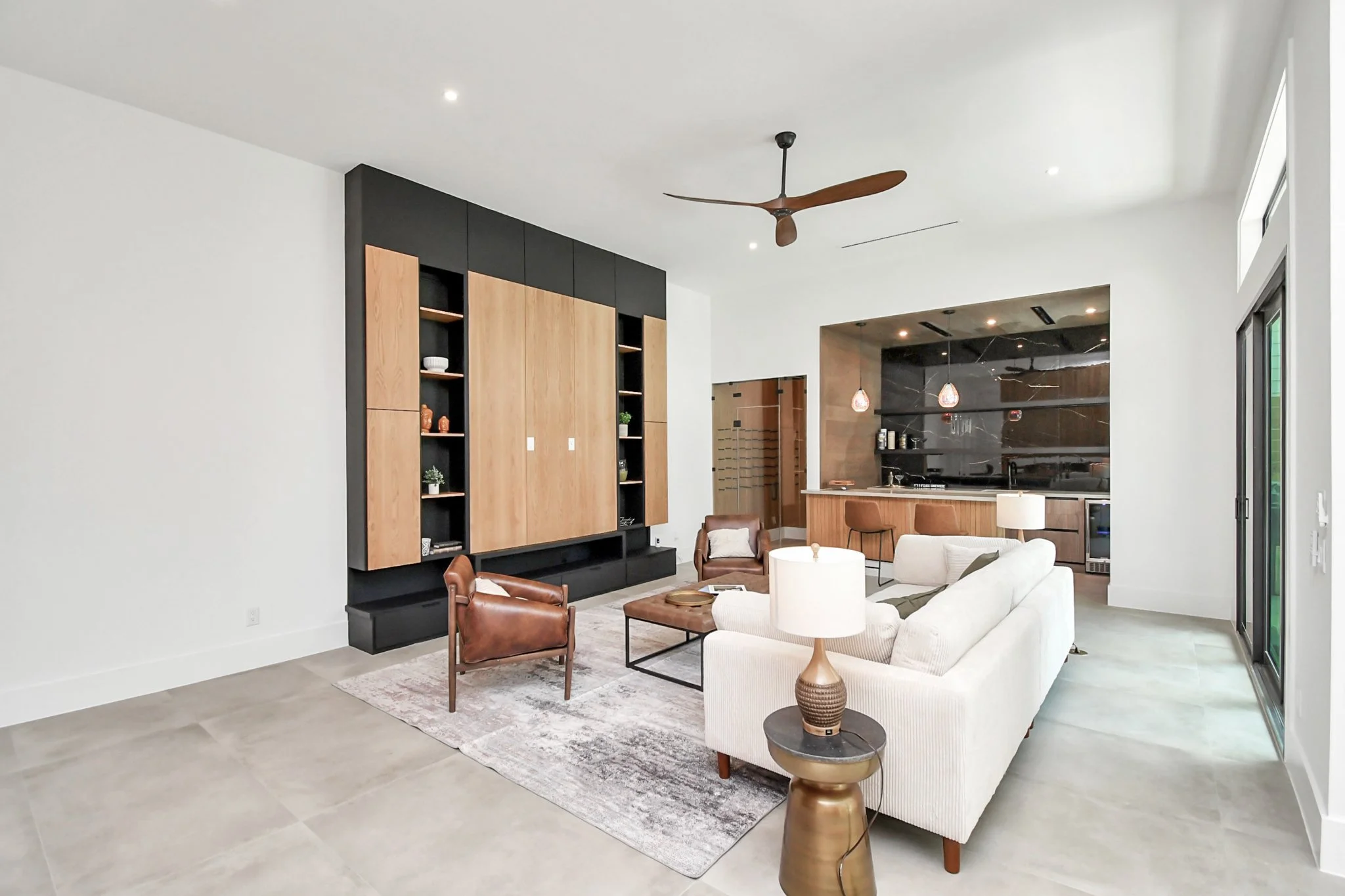 A sophisticated living area defined by custom millwork, elevated finishes, and a seamless connection to a private entertaining space.