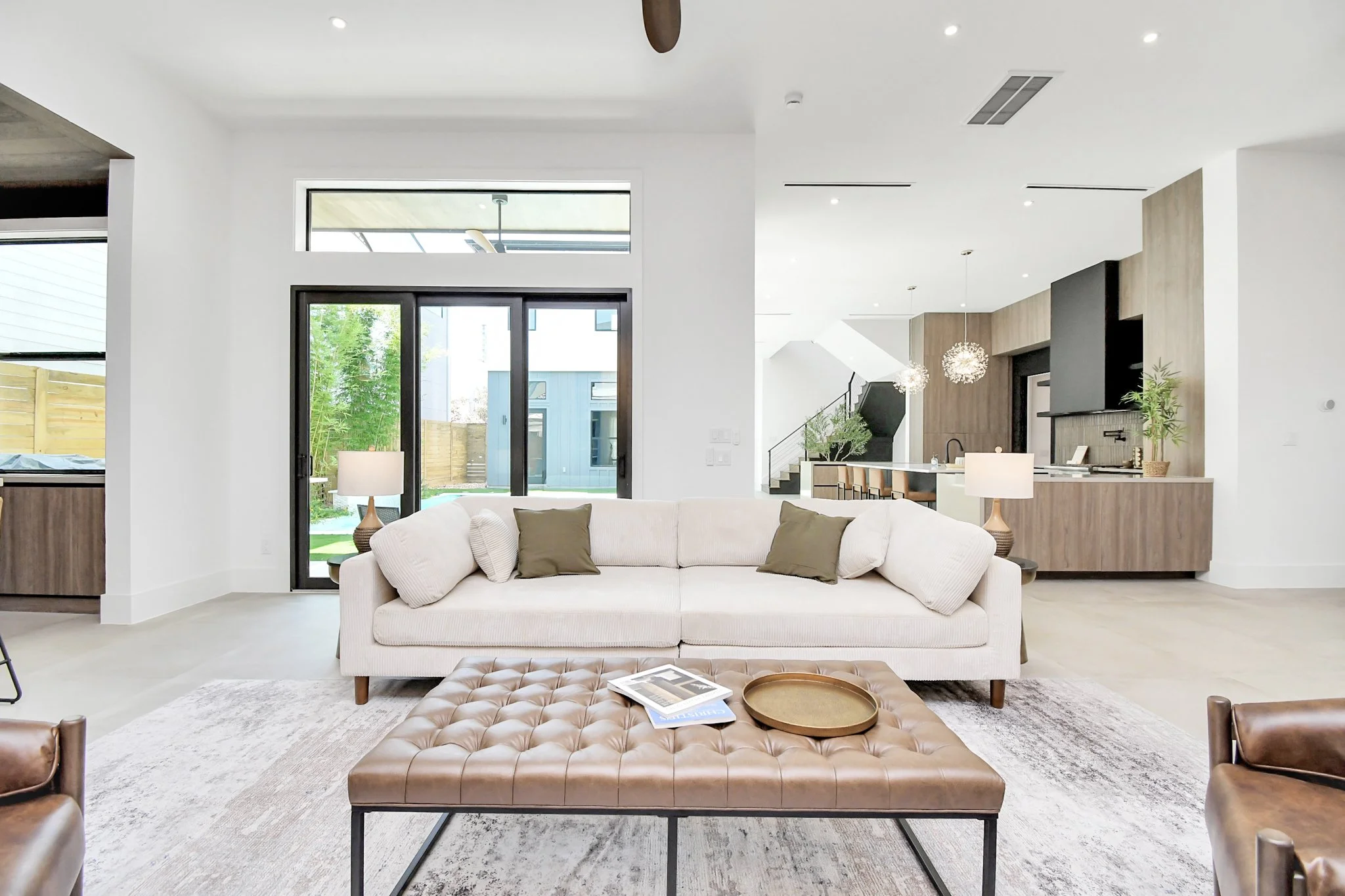 An open-concept living space filled with natural light, featuring clean modern lines, warm textures, and seamless indoor-outdoor flow for elevated everyday living.