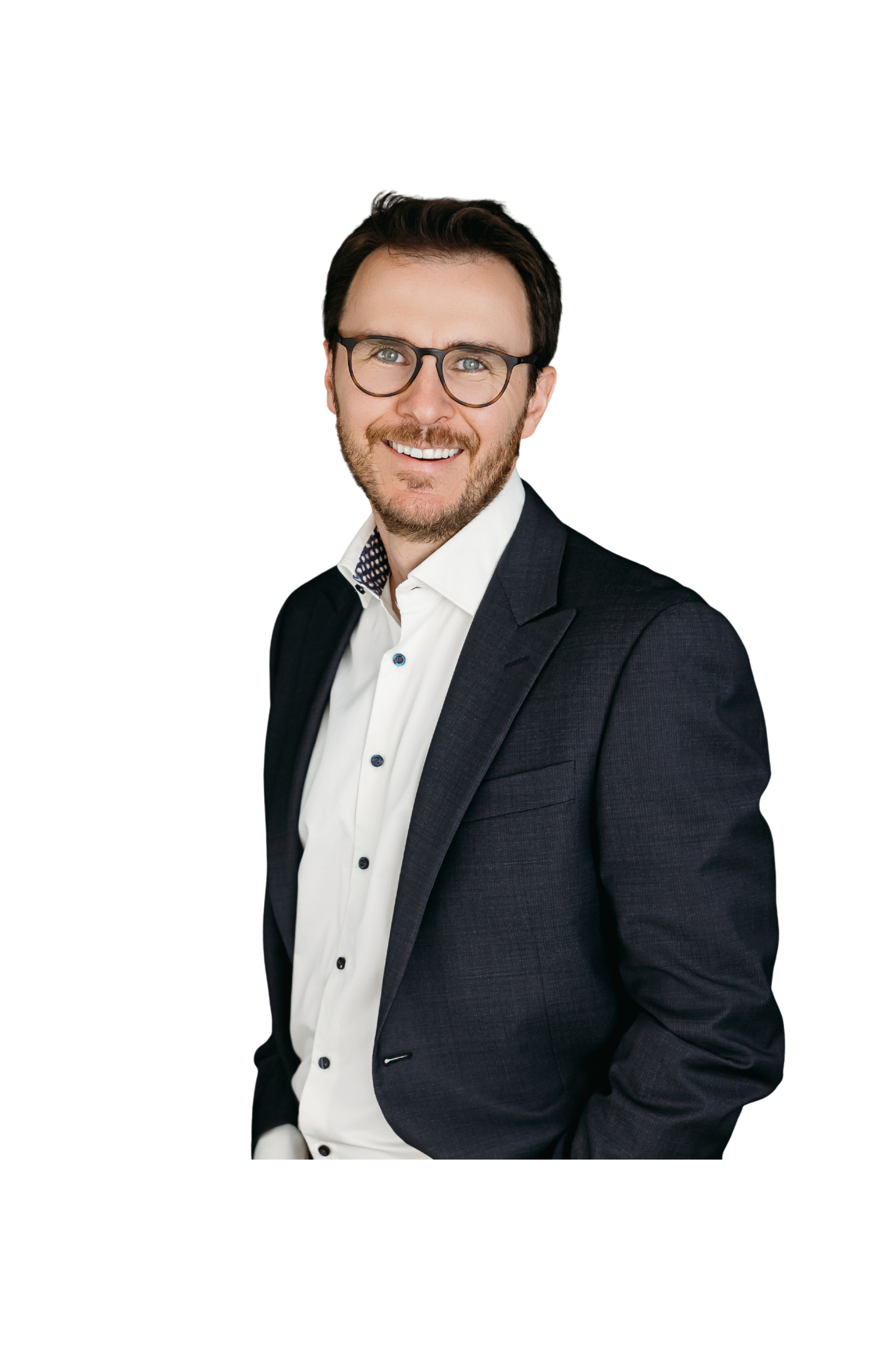 A man with dark hair, glasses, and a beard, smiling in a business suit and white shirt, against a white background. Anthony Gatti, CTO of NodeAI