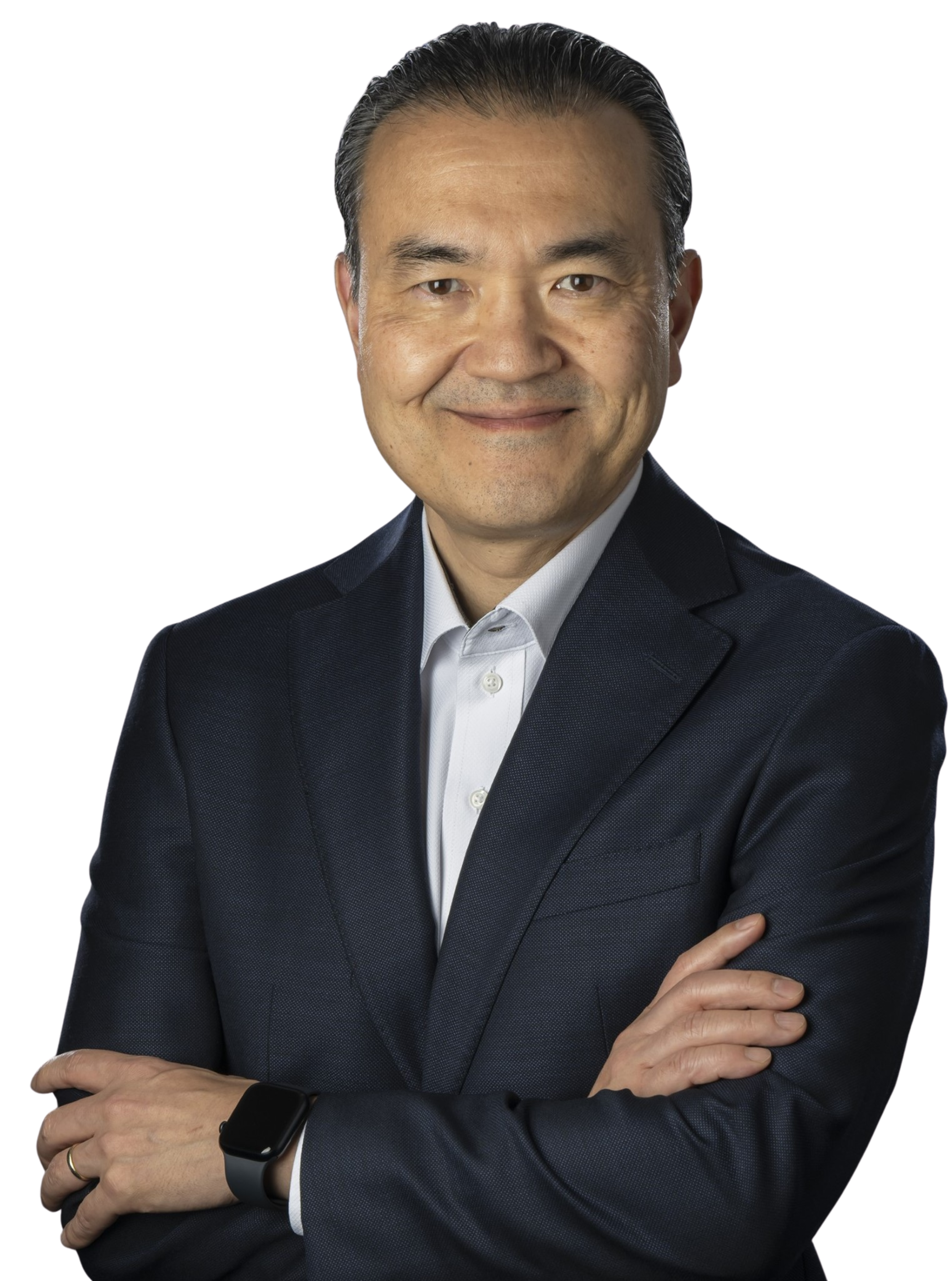 A man in a business suit with crossed arms, wearing a smartwatch on his left wrist, smiling in front of a white background Kazuhiro Yasufuku 