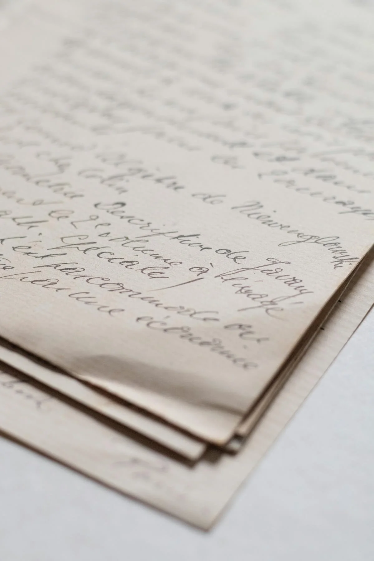 Close-up of handwritten letter on cream-colored paper with cursive writing.