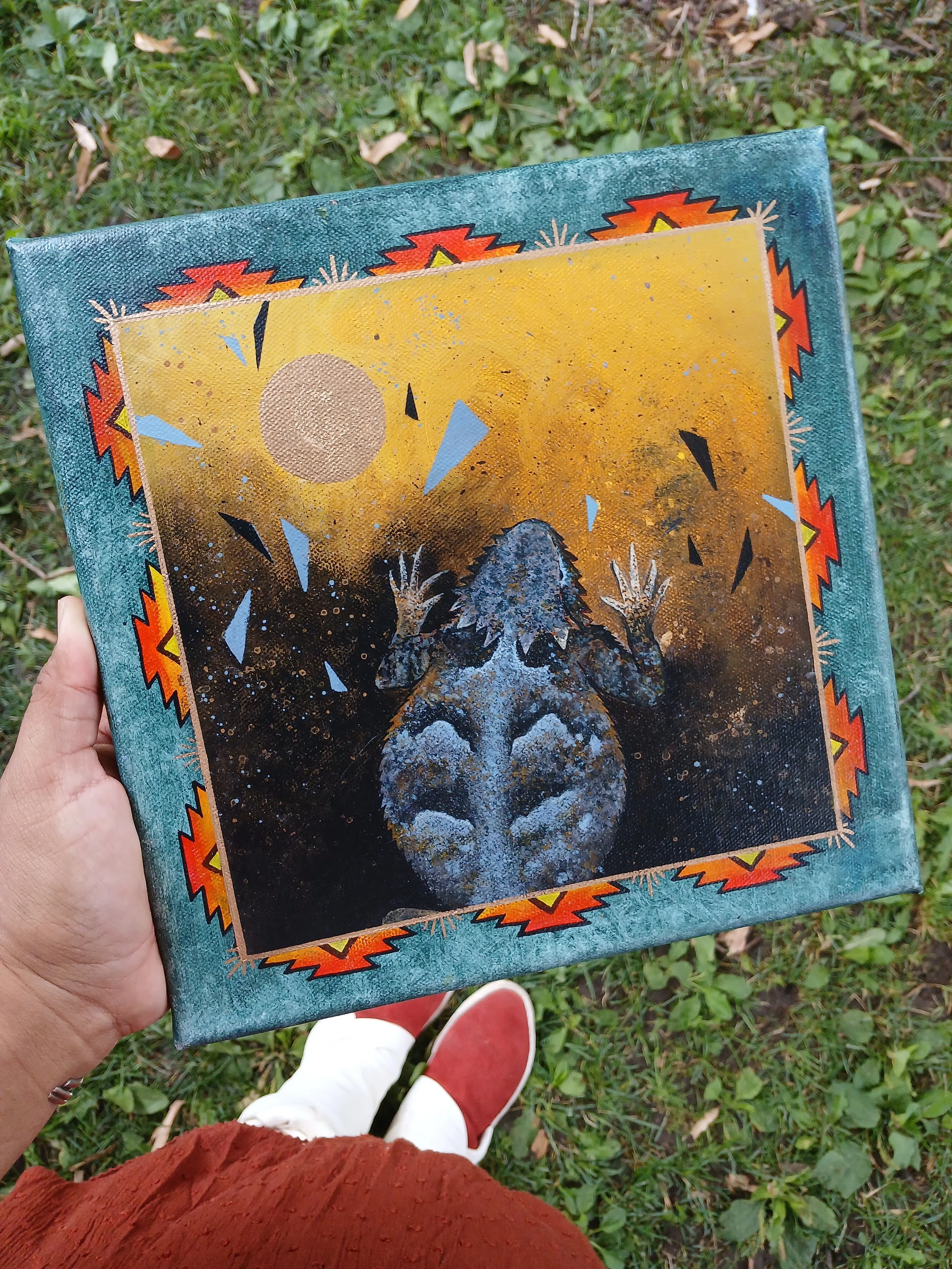 An acrylic painting featuring a Cheii surrounded by a geometric background. Sold during 2025's SWAIA event in Santa Fe.