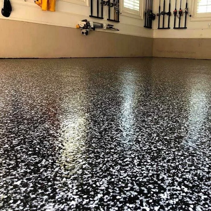 Close-up of a shiny, speckled black and white epoxy garage floor 