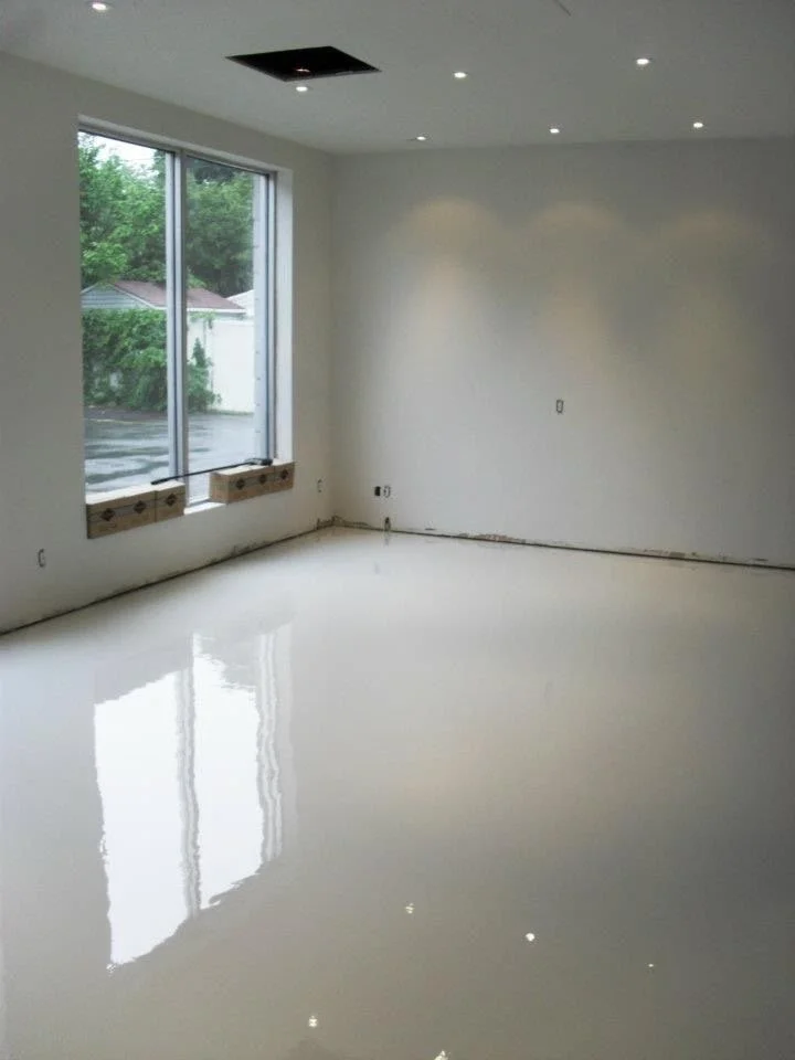 Empty room with polished clear solid color epoxy floor