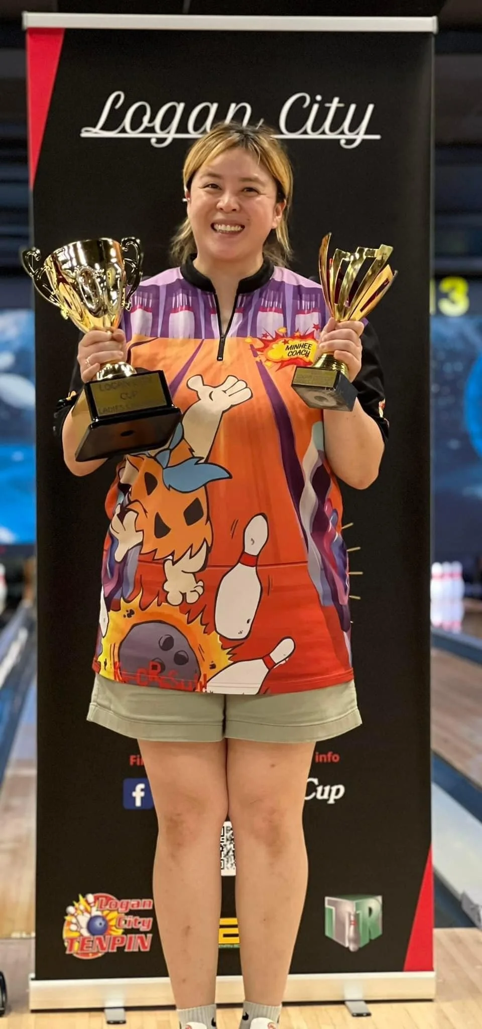Minhee Kim holding her trophies for winning the 2024 Logan City Cup.