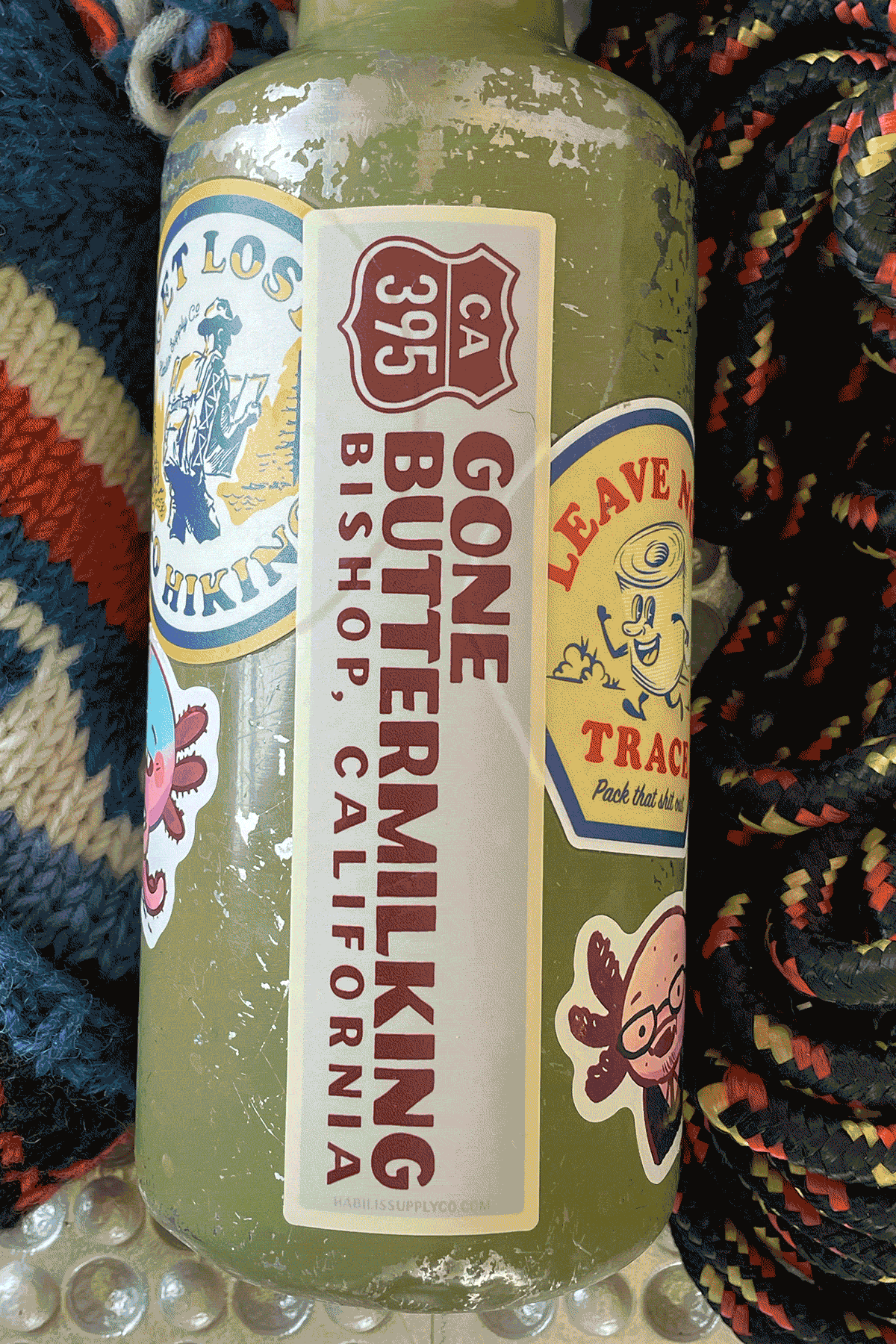 a collection of hiking and backpacking stickers on a water bottle