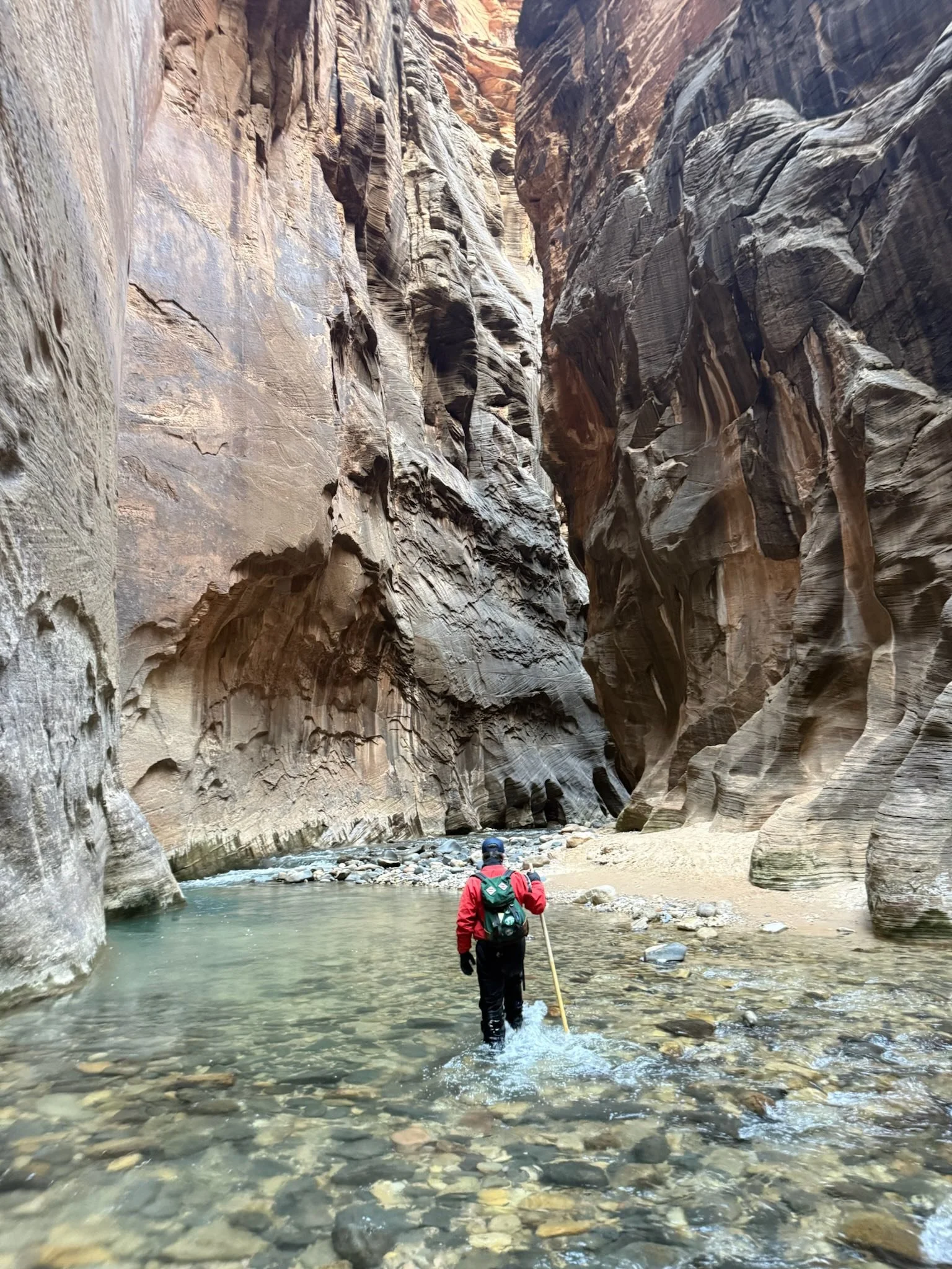man hiking in zion narrows
