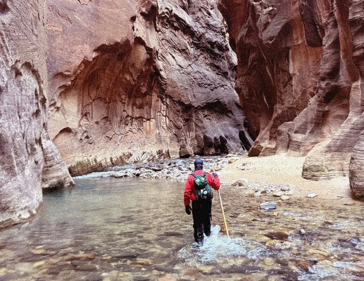 Man hiking in the Narrows at Zion National Park