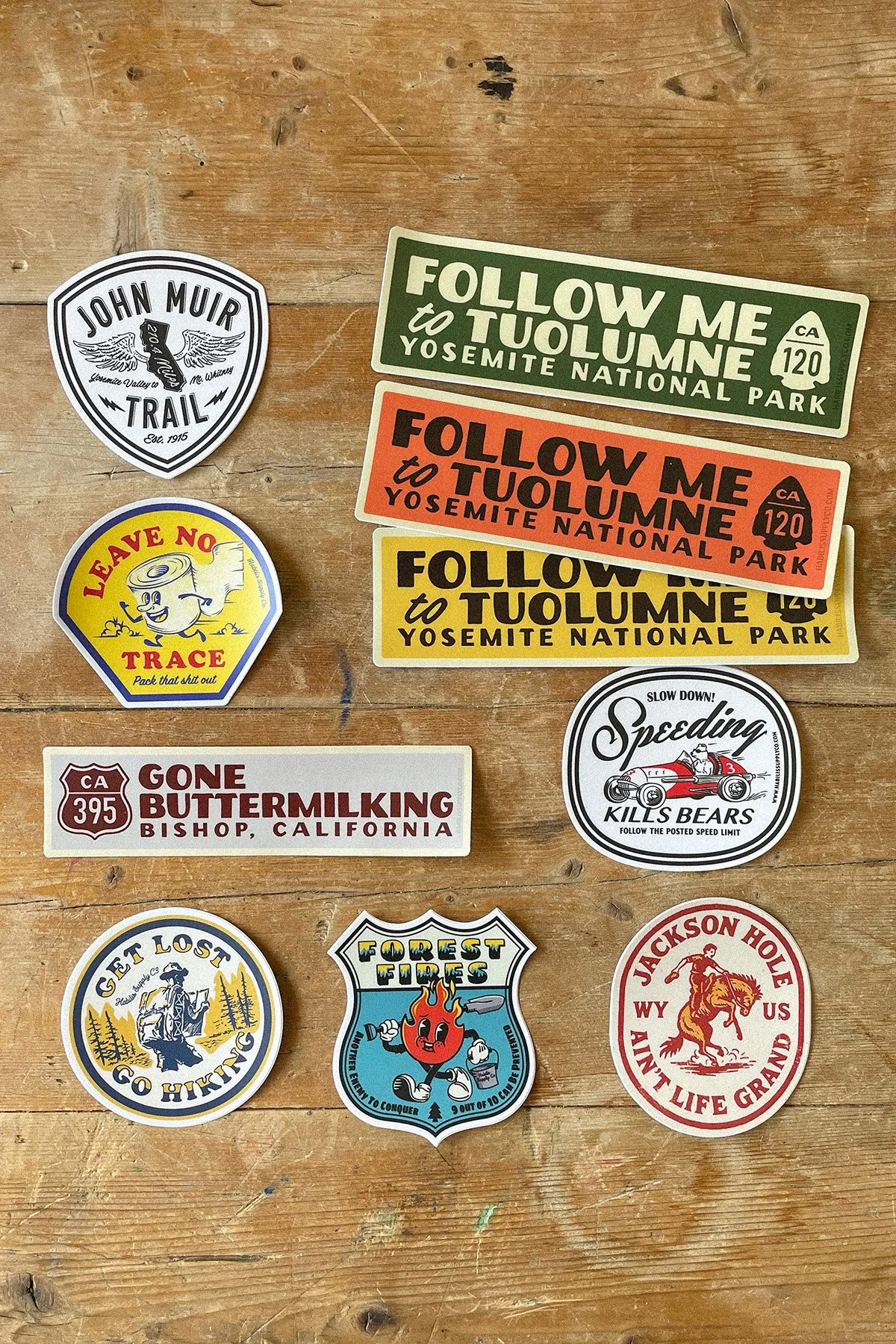 habilis supply co sticker collection laid out on a wooden table