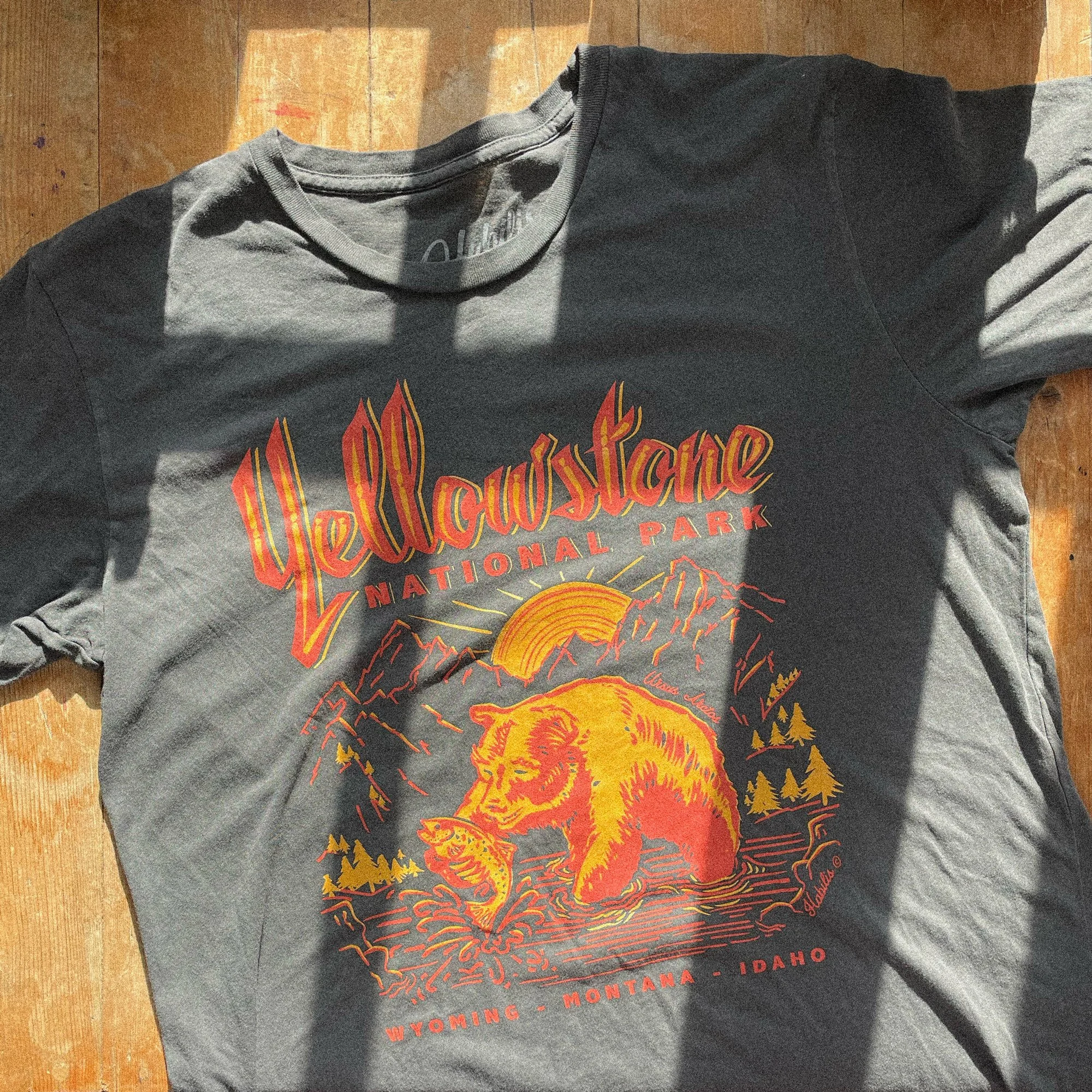 yellowstone national park shirt laid flat on a table