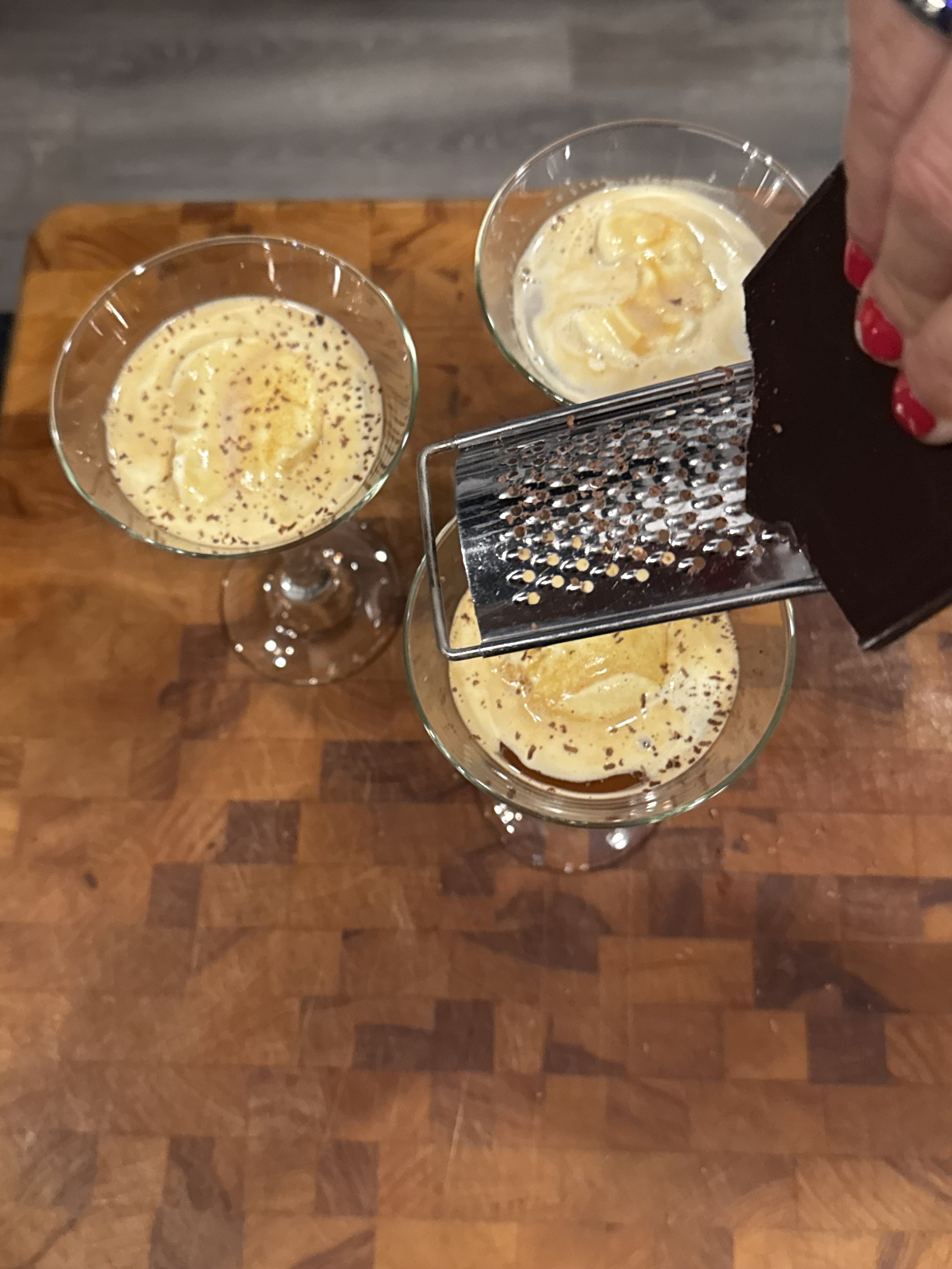 Affogato with vanilla ice cream and hot espresso topped with grated chocolate