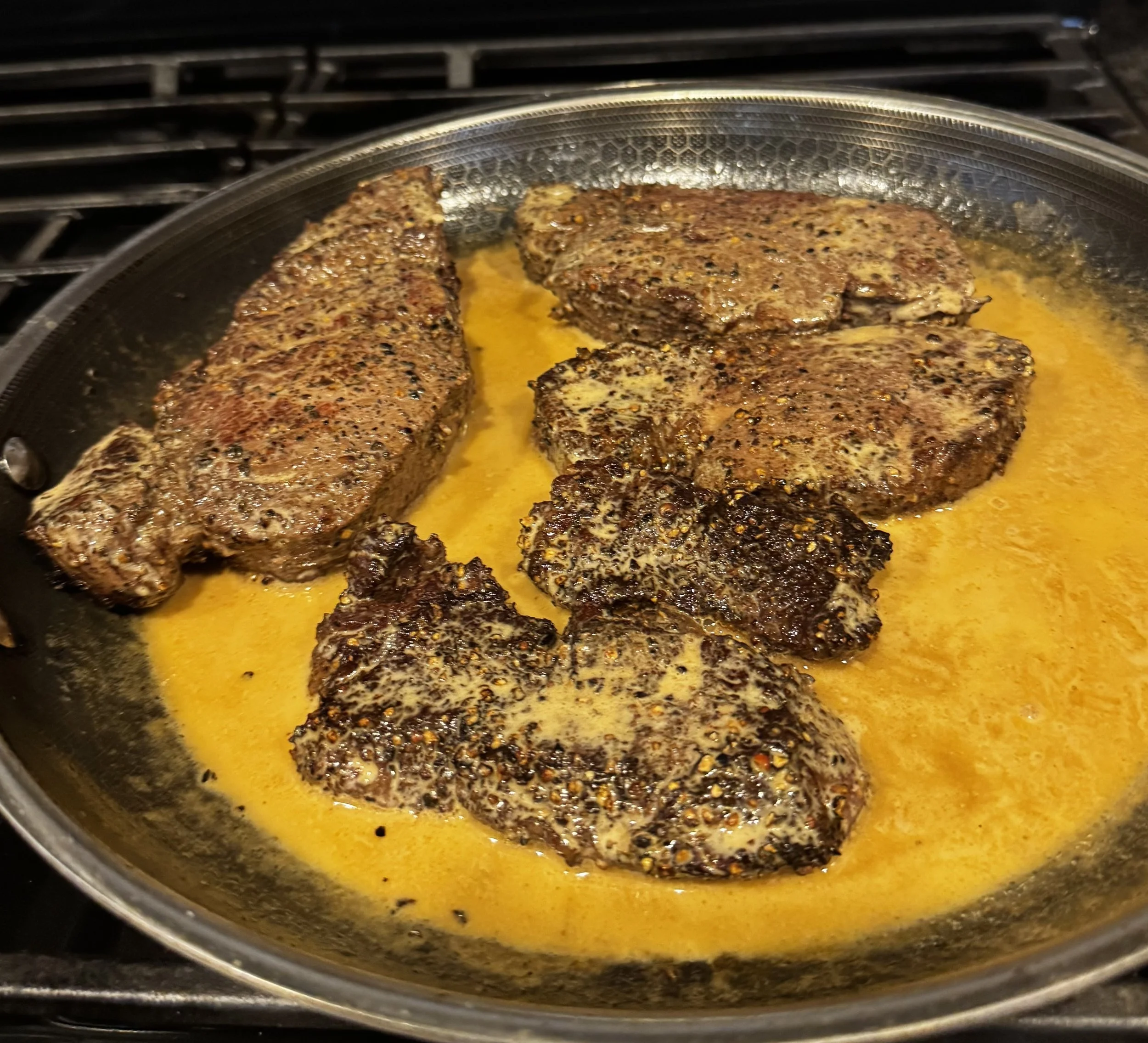 Whiskey Ridge Steak au Poivre with cognac cream sauce in the pan after the flambé.
