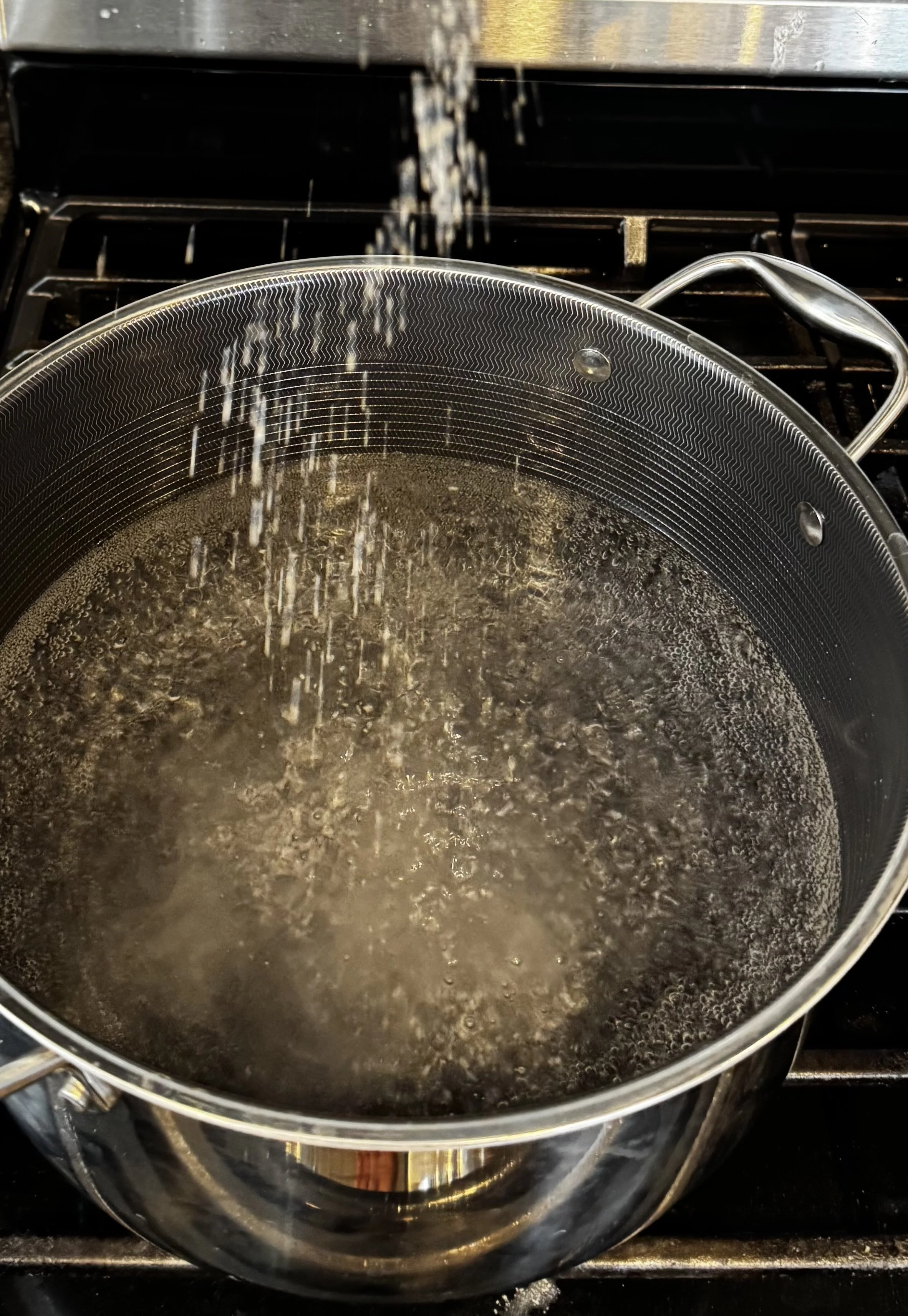 Pot of boiling salted water for cooking spaghetti.