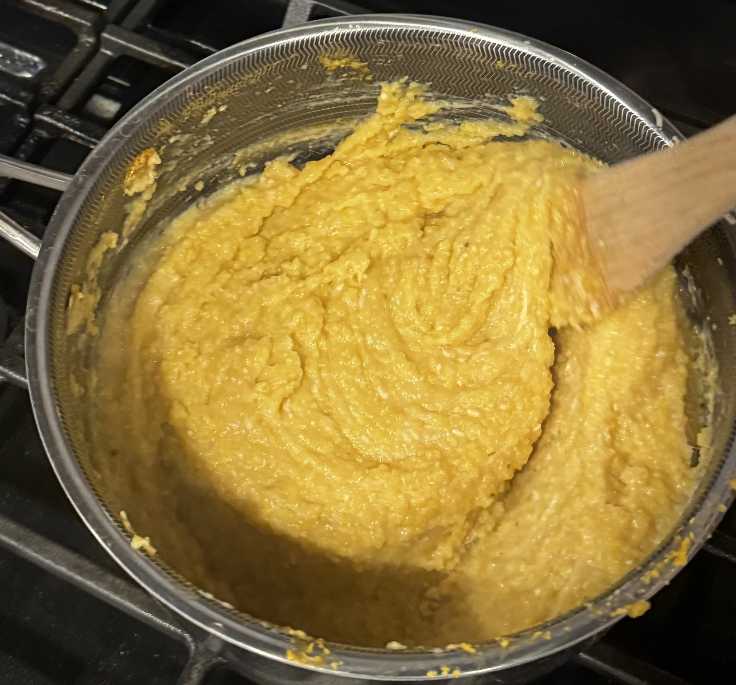 Thick and creamy polenta in saucepan