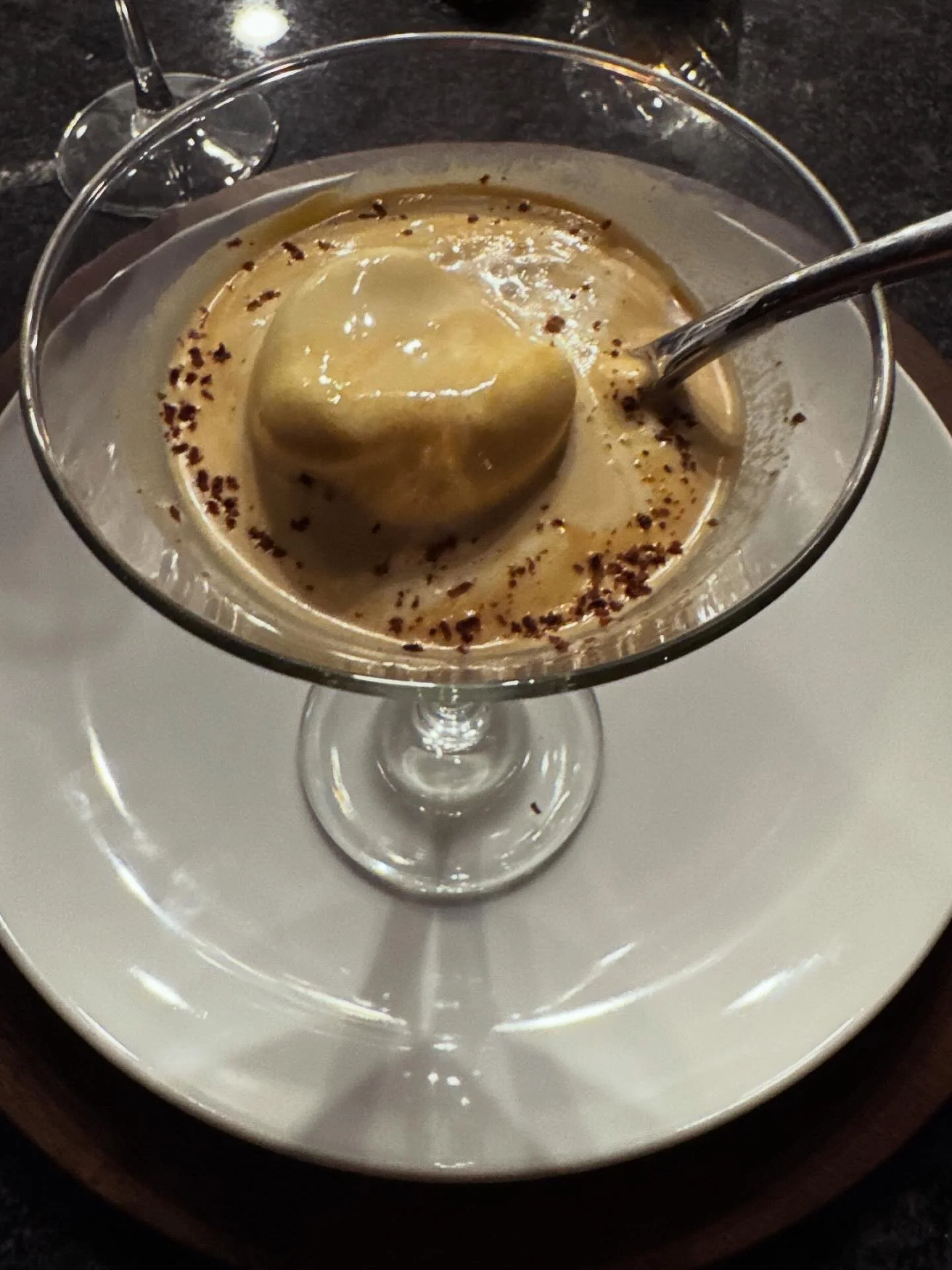 Affogato made with homemade vanilla ice cream and fresh espresso in a glass dessert coupe