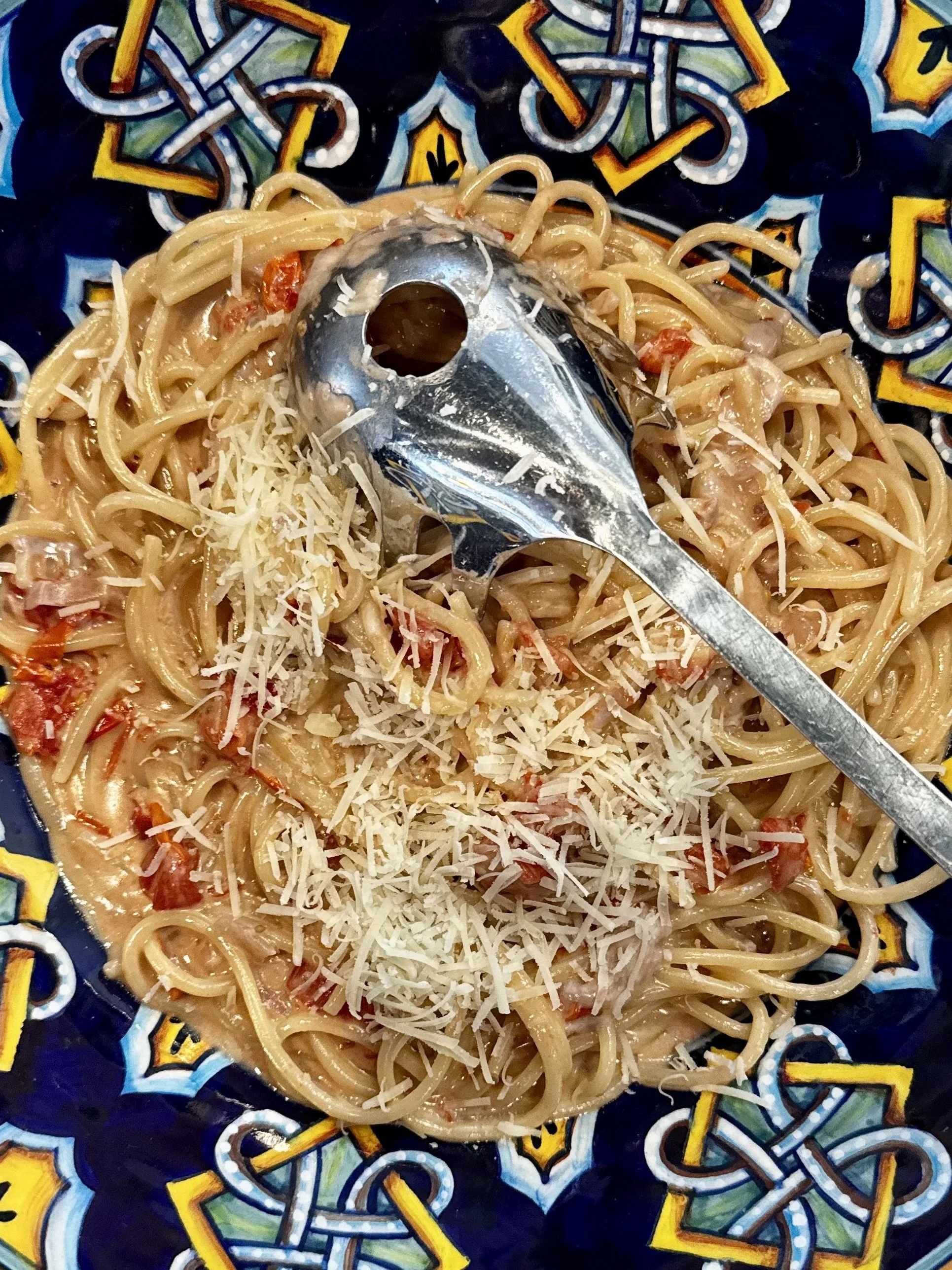 Spaghetti with red wine cream sauce, cherry tomatoes, and Parmigiano Reggiano cheese