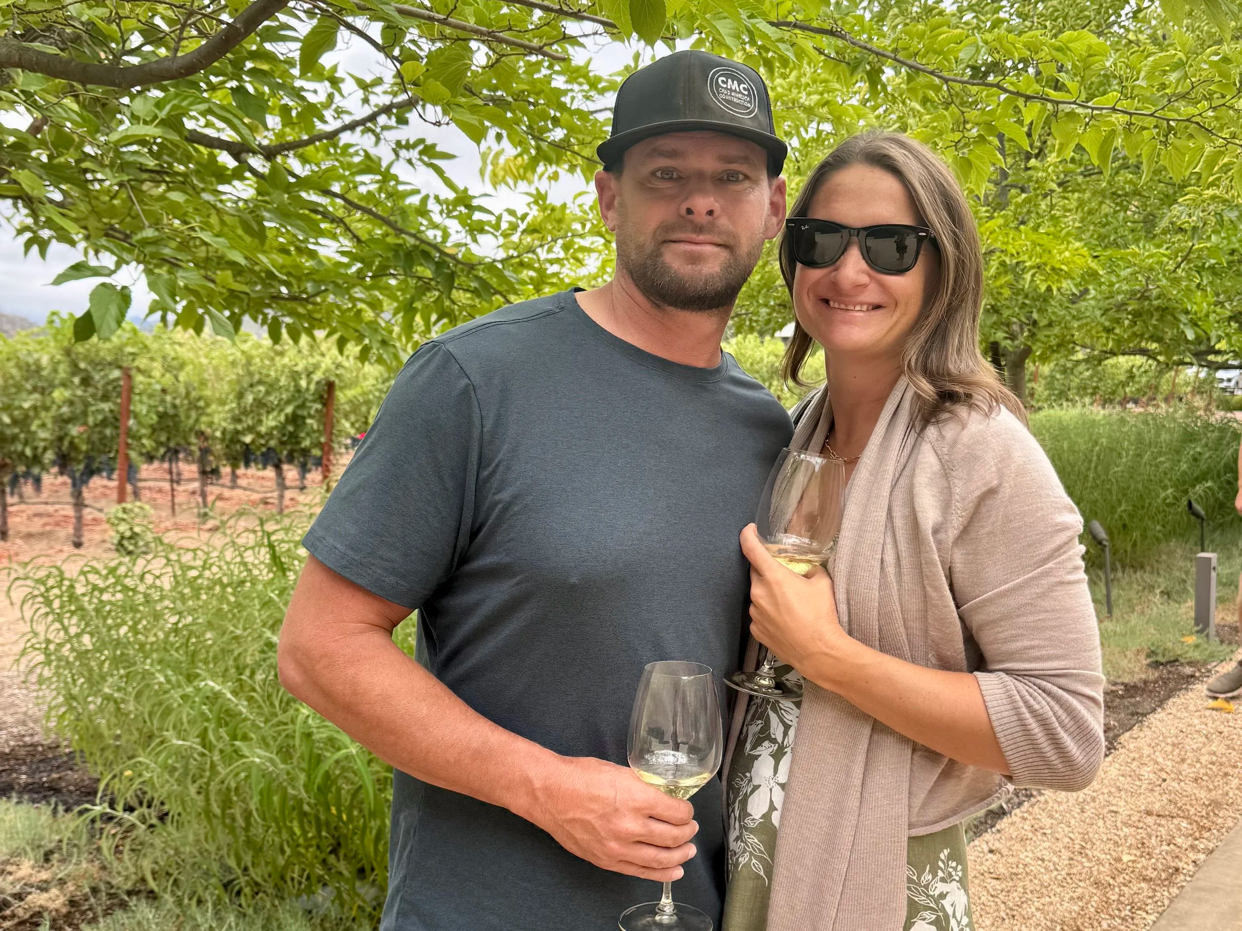 Anne Mihelich and husband at napa winery holding wine glasses