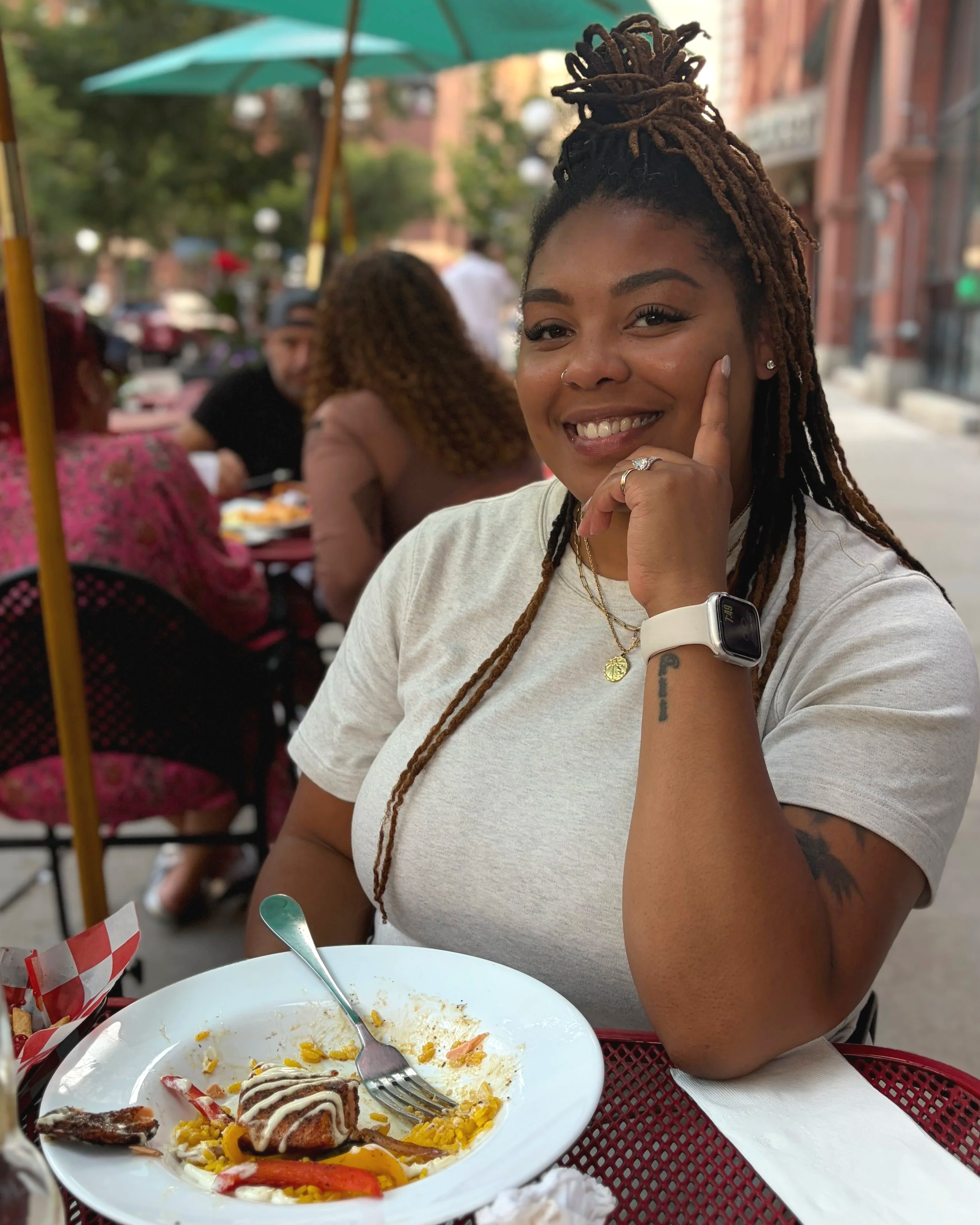 Woman with locs smiling at the camera
