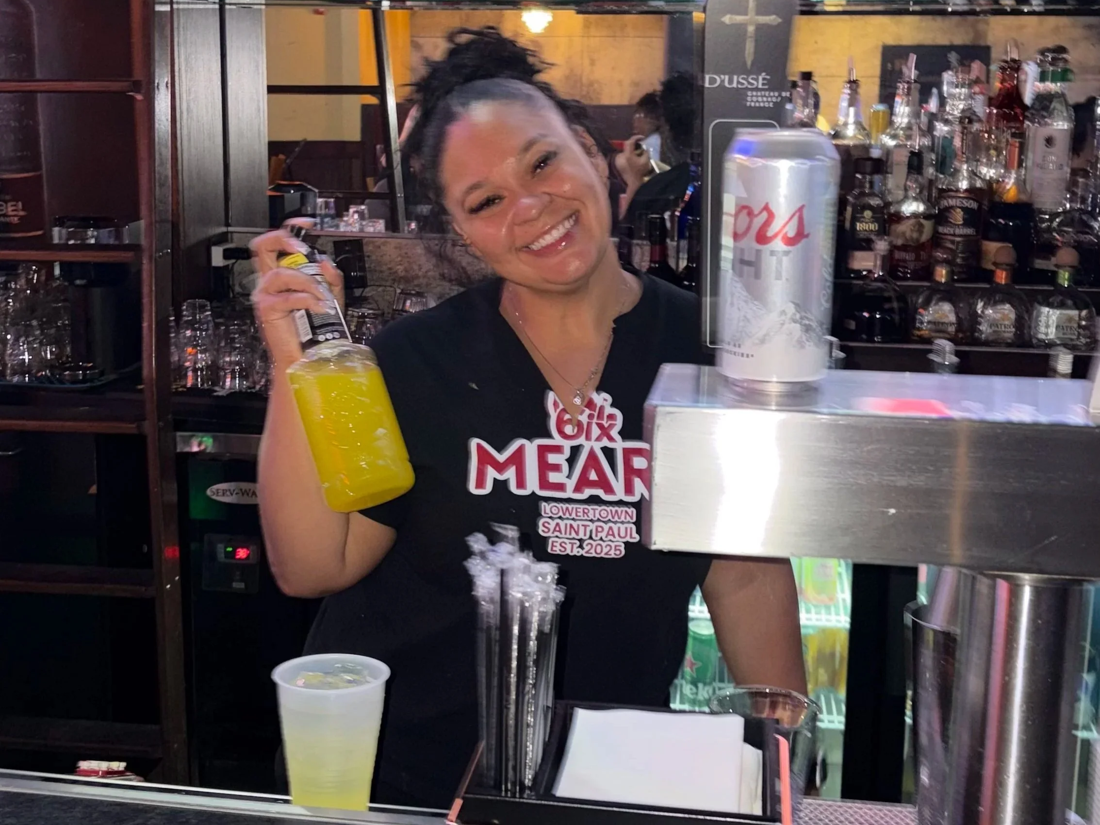 6ix Mears Bartender holding a drink mixer