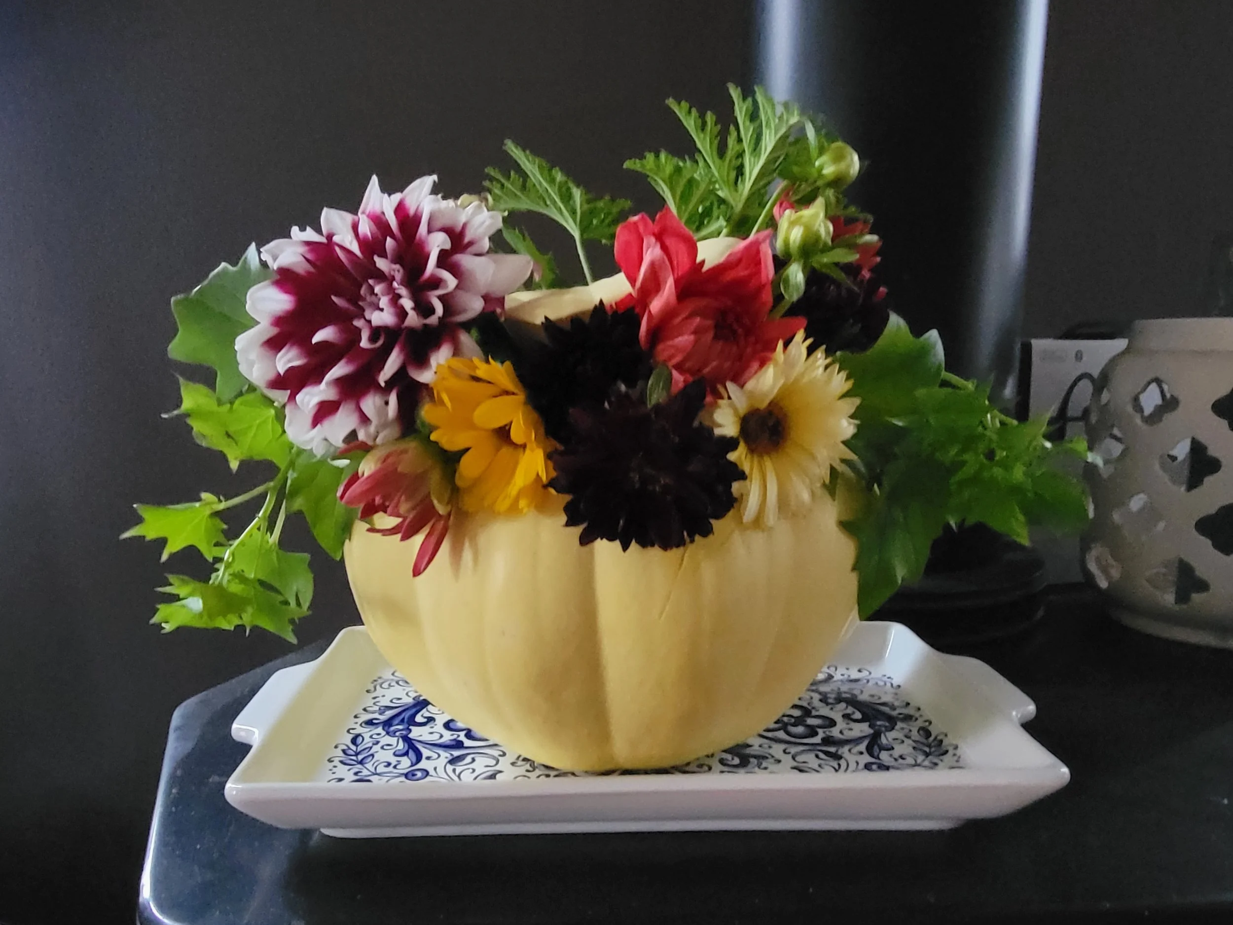 A pumpkin flower arrangement with Dahlias, calendula and ivy.