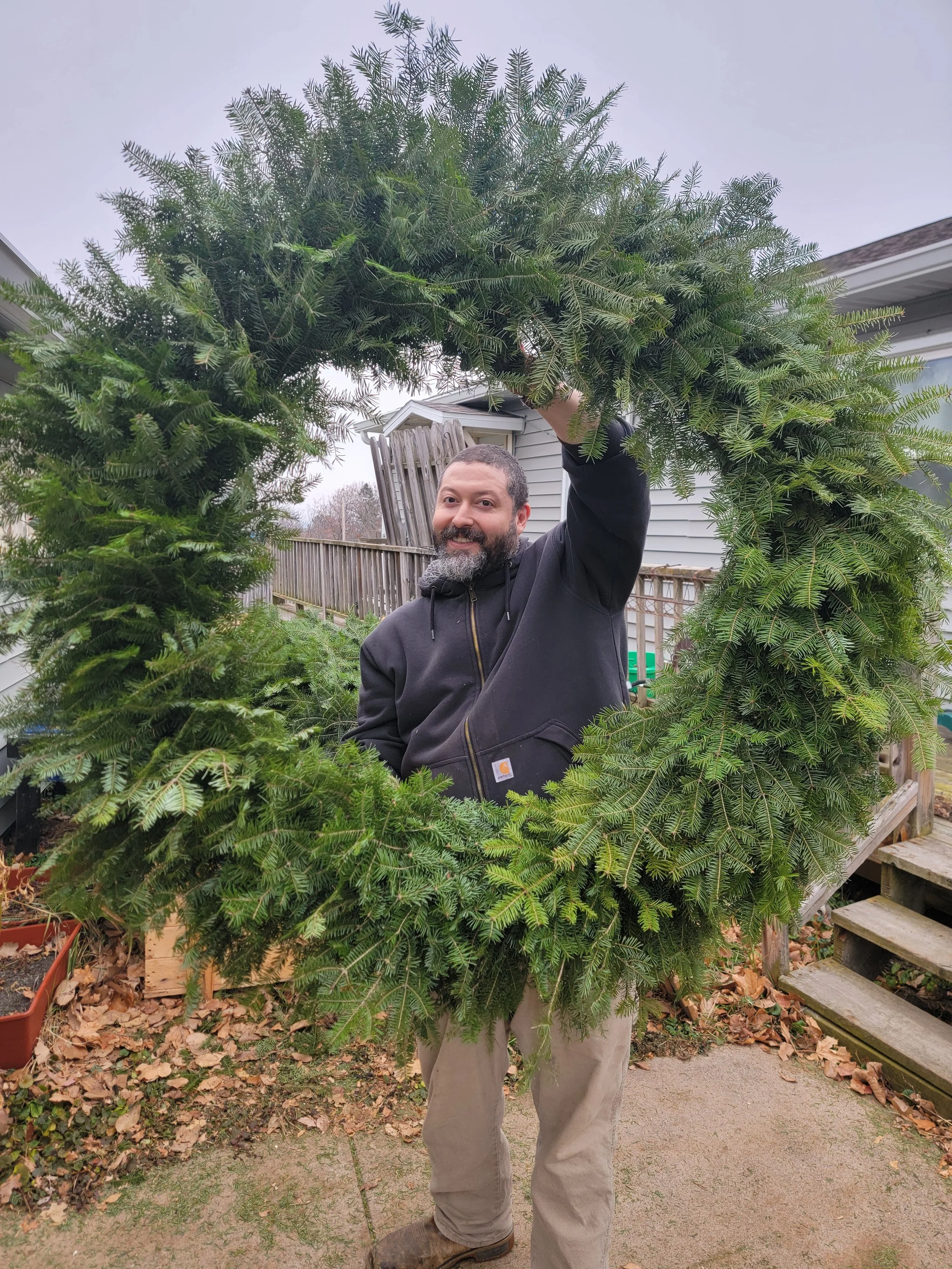 We offer wreaths of different sizes, Eduardo is modeling our 48" wreath.