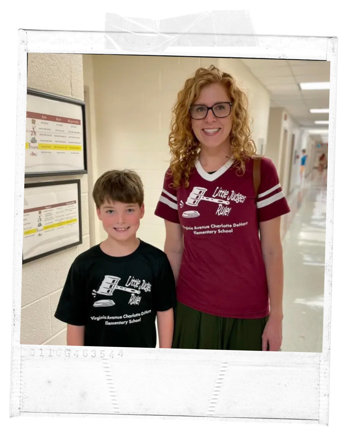 A woman and a young boy standing in a school hallway smiling at the camera. They are both wearing matching shirts with the text 'Little Judges Ruler' and the school's name, Virginia Avenue Charlotte D. Hart Elementary School.