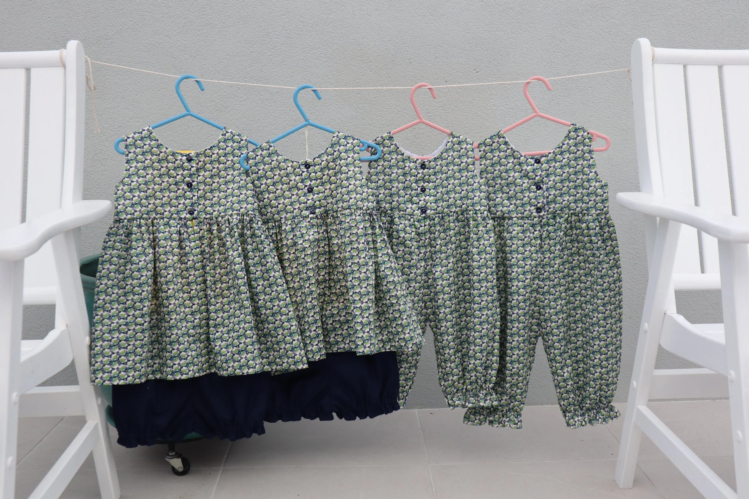 Liberty print oncies and tops and bottoms backs.JPG