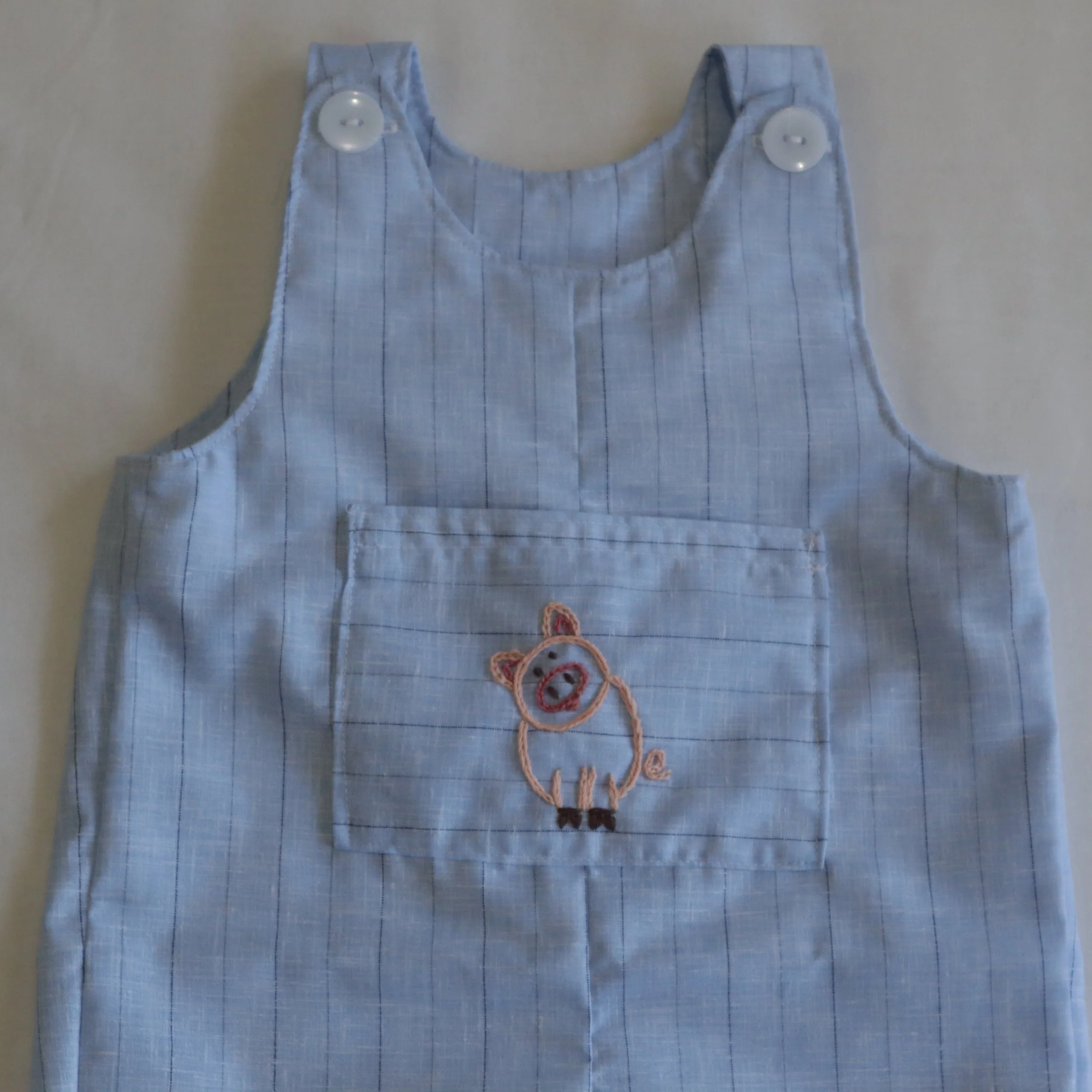 Pig embroided overall front pocket.JPG