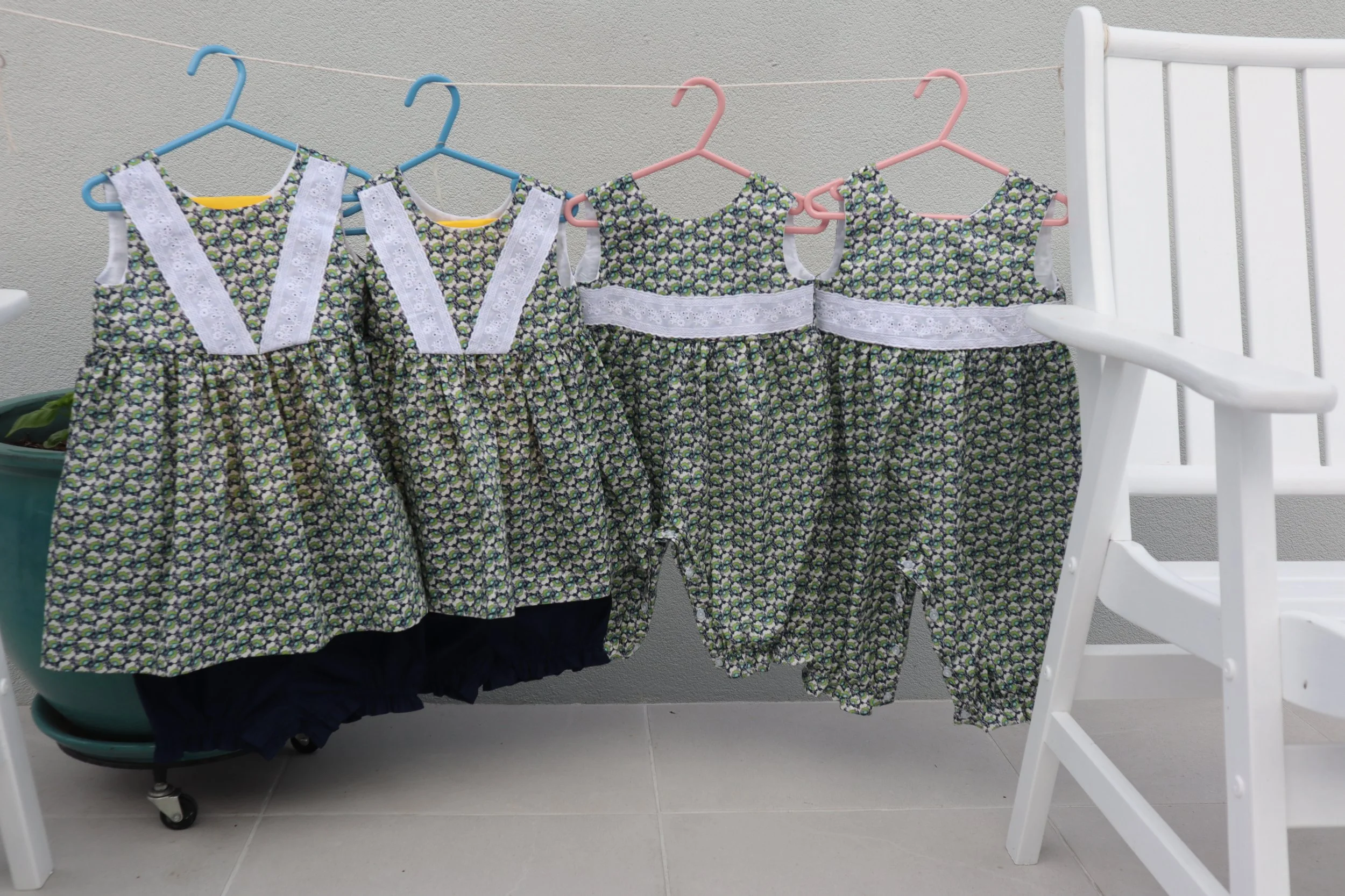 Liberty print oncies and tops and bottoms front.JPG
