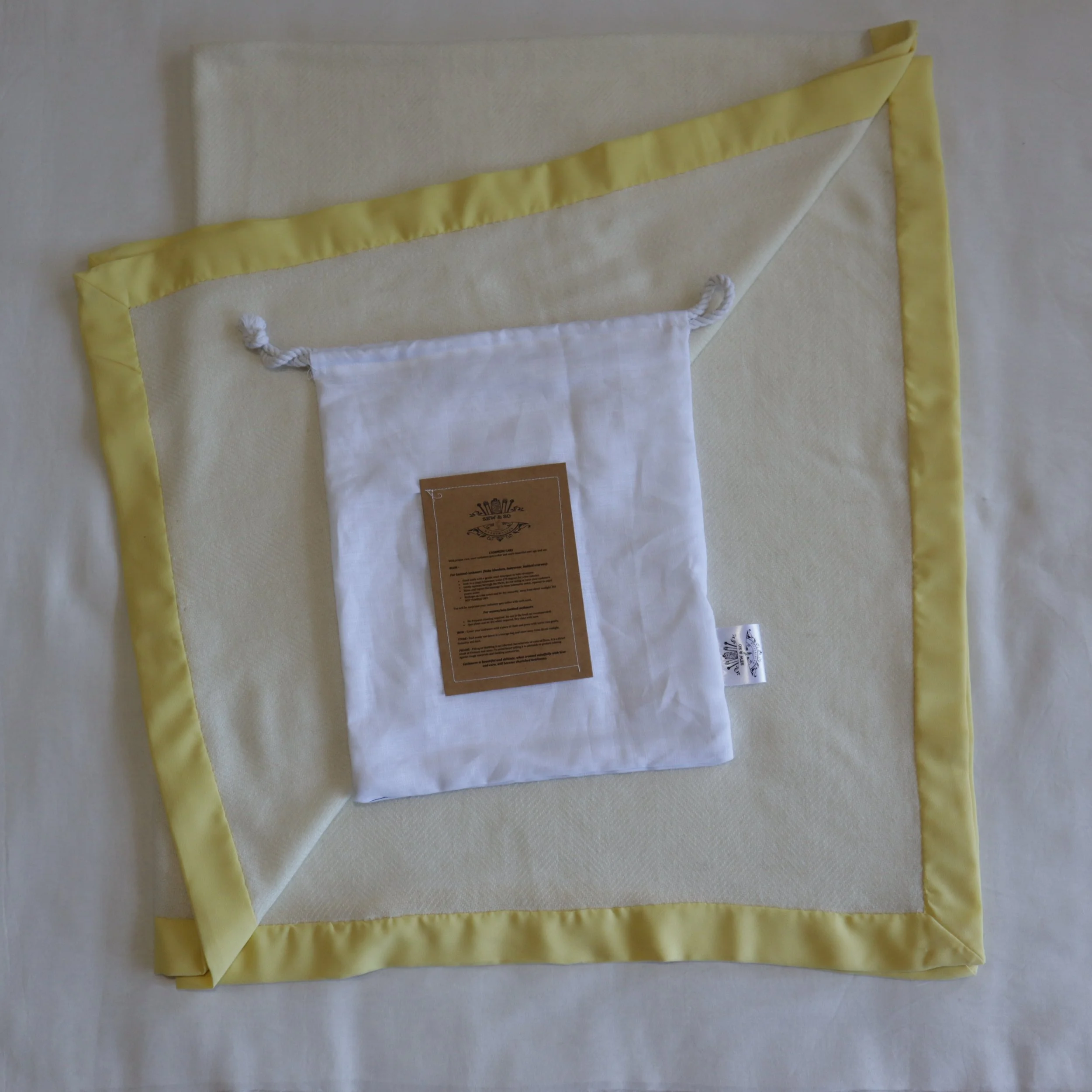 Cashmere cream toddler blanket and yellow border with Linen dust proof bag.JPG