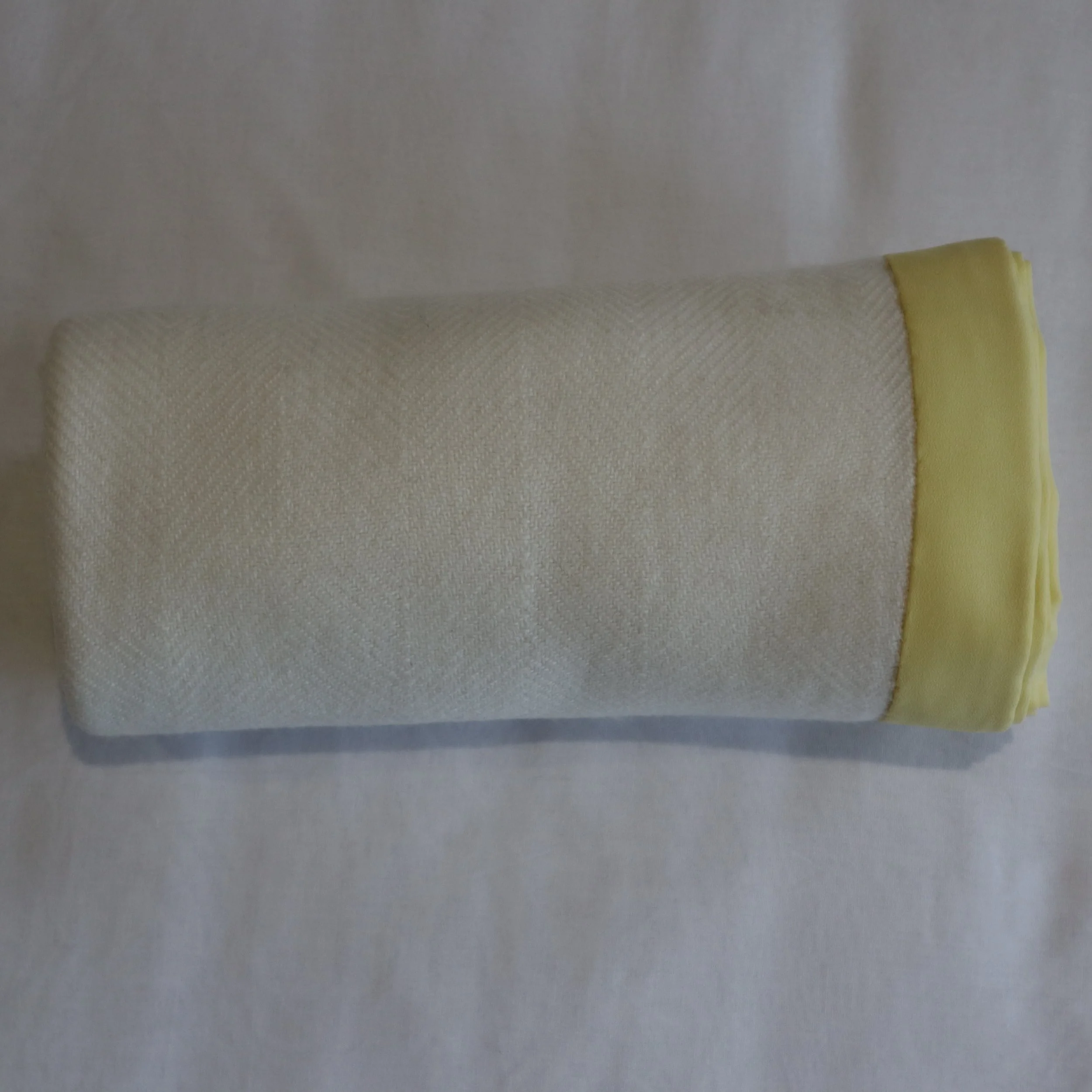 Cashmere cream toddler blanket and yellow border rollerd.JPG