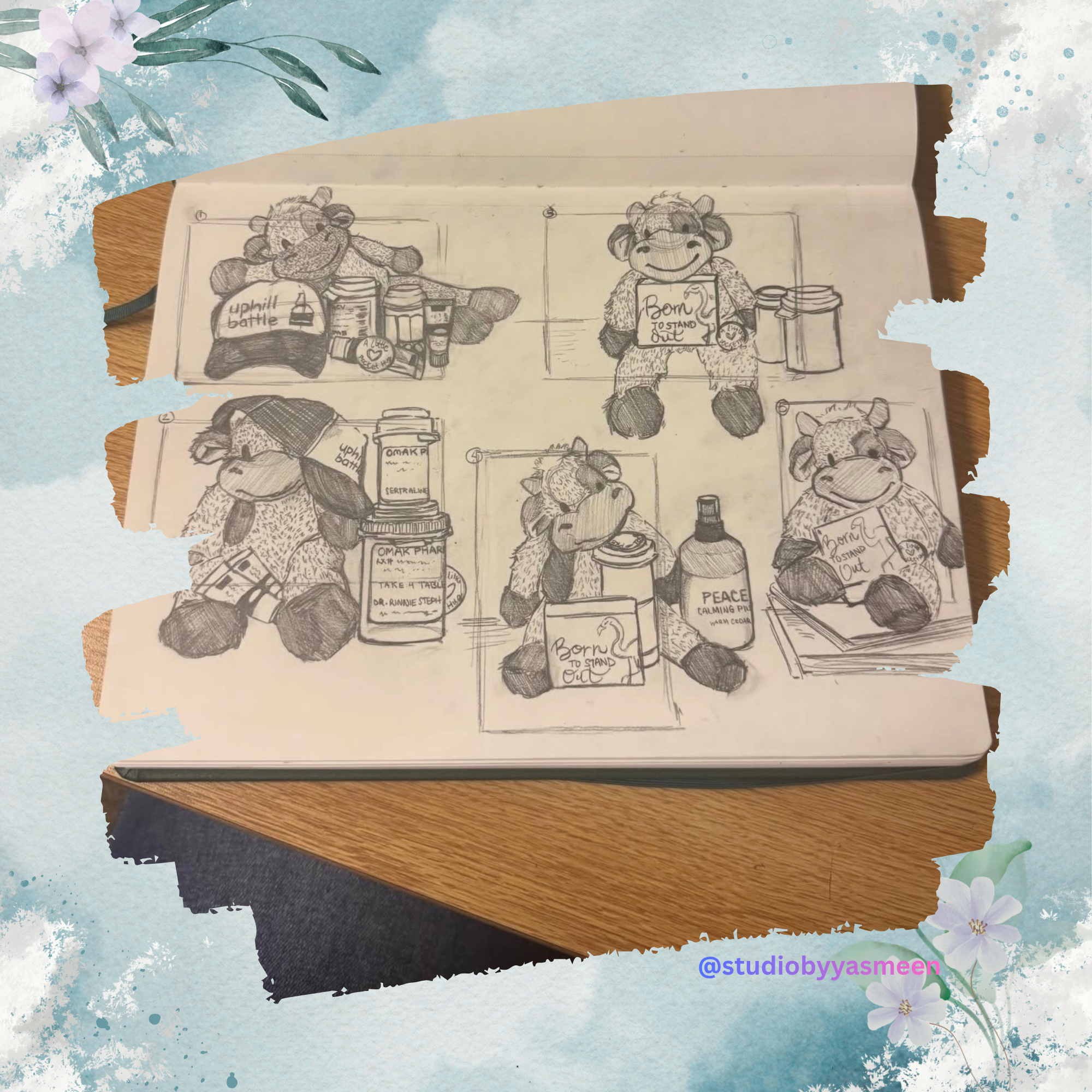 Sketch of a cartoon bear character in various poses holding and surrounded by different bottles of oils, medicines, and a book with 'Born to stand out' written on it. Some bottles have labels like 'Peace Calming Oil' and 'OMAK PHAR.' The sketch is on a piece of paper on a wooden surface, with a floral border around the photo.